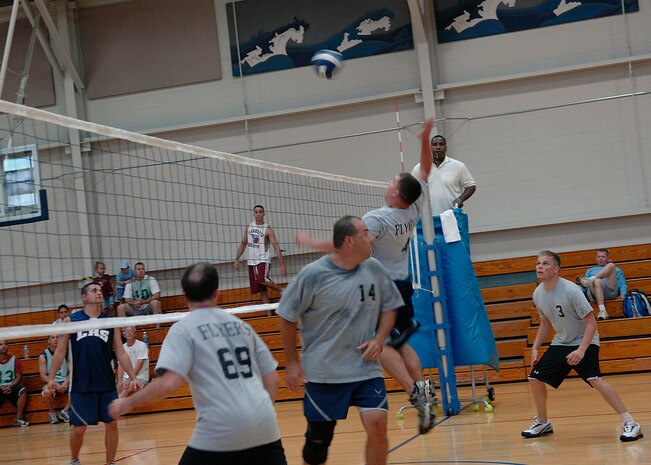 Ryan Evans spikes the ball to the LRS 1 team during an intramural volleyball match on base Sept. 9. The Flyers/OSS team beat the LRS 1 team 25-16, 25-21. Evans is from the 17th Airlift Squadron. (U.S. Air Force photo/Airman 1st Class Katie Gieratz)