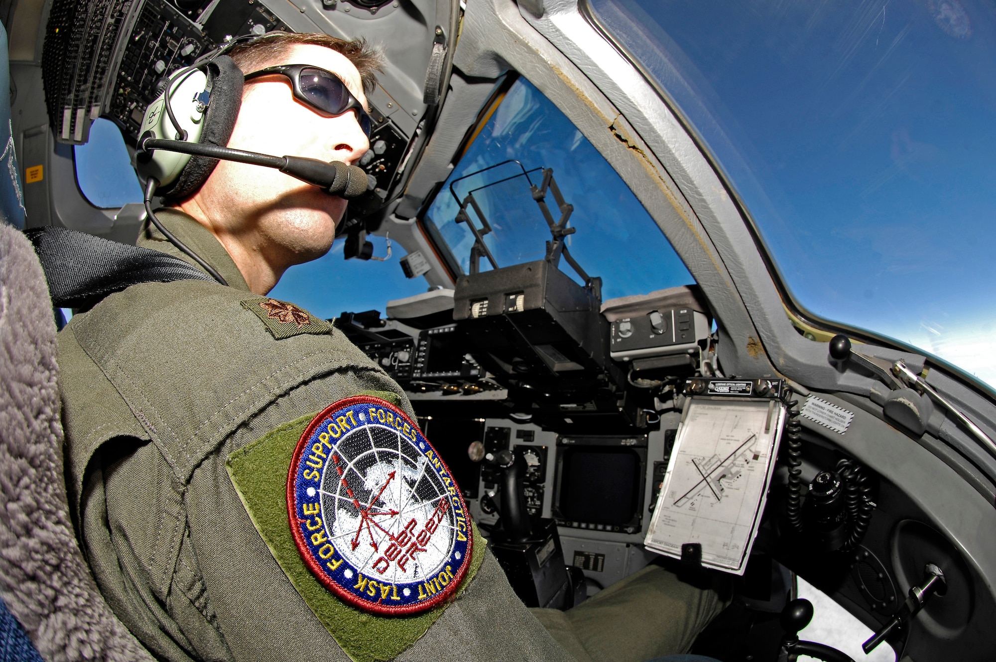 Maj. Jason Allen, a Reserve C-17 evaluator pilot with the 97th Airlift Squadron at McChord Air Force Base, Wash., looks out over the ice as he delivers more than 64,000 pounds of supplies and equipment to Antarctica on Sept. 10.  The cargo movement was conducted by Joint Task Force Support Forces Antarctica, headquartered at Hickam AFB, Hawaii, and led by 13th Air Force.  The joint task force is currently conducting Operation Deep Freeze in support of the National Science Foundation and U.S. Antarctic Program.    (US Air Force photo / Master Sgt. Chris Vadnais)
