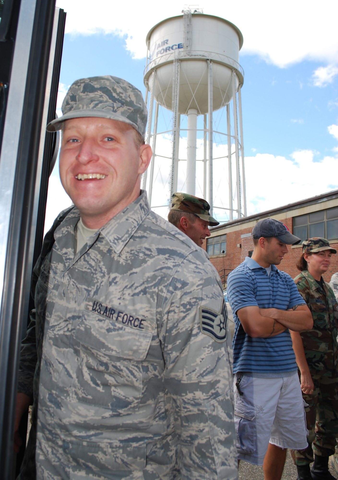 Staff Sgt. XXXXX, 439th Aeromedical Staging Squadron, smiles before boarding a military bus for his long trip ahead to Southwest Asia. Sergeant XXXXX and about 19 Airmen from ASTS and the 42nd and 58th Aerial Port Squadrons deployed Sept. 10. Their overseas tour of duty will last about four months. (US Air Force photo/Tech. Sgt. Andrew Biscoe)