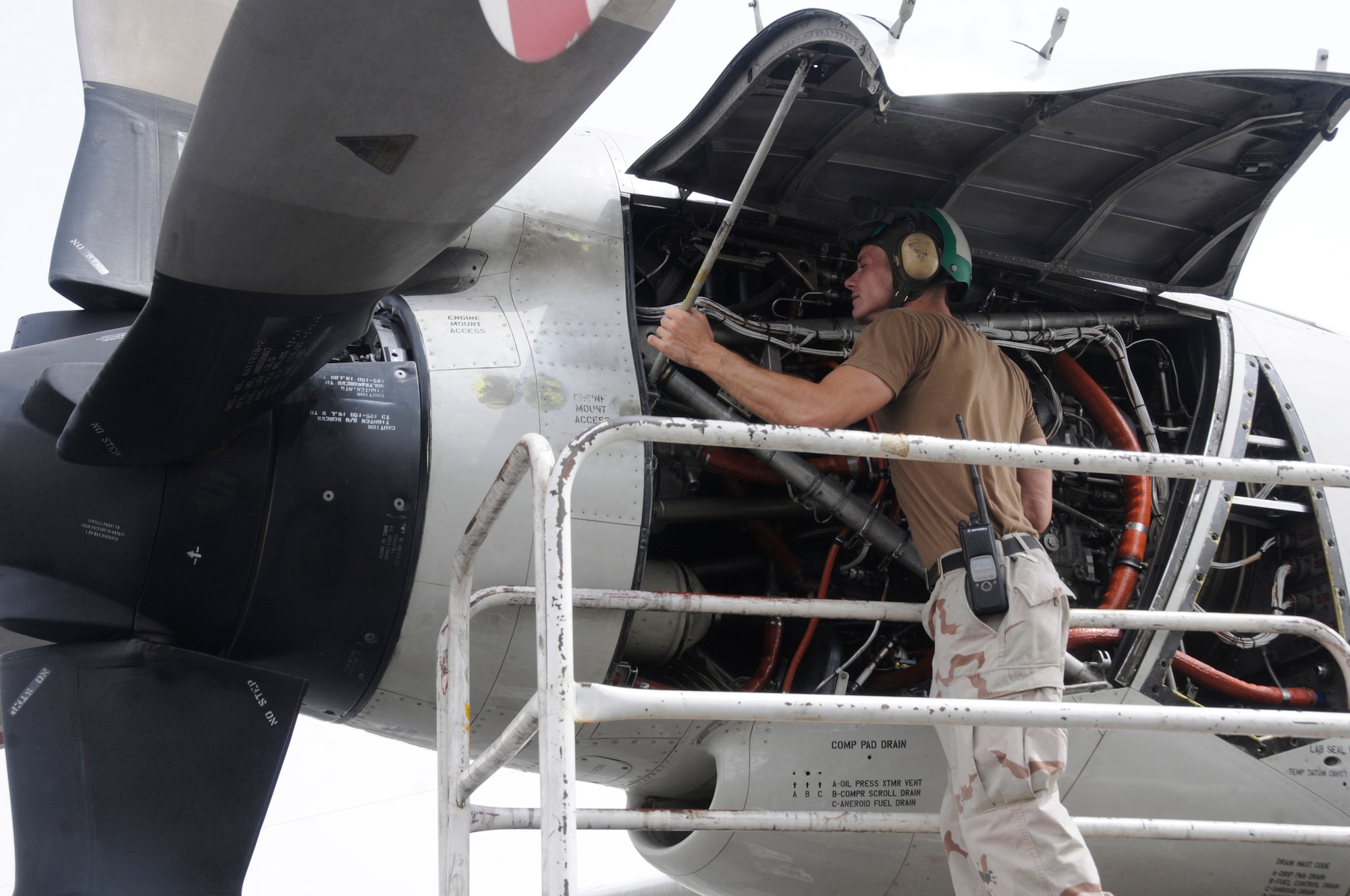 Petty Officer 2nd Class Kevin Leonard, aviation structural mechanic, checks the T56A-14 turboprop engine on a P-3C Orion aircraft to ensure that it is clear of debris Sept. 9, 2008, at an undisclosed air base in Southwest Asia. The P-3 aircraft provides surveillance of the battlespace, either at sea or over land. Its long range and long loiter time have proved invaluable assets during Operations Iraqi and Enduring Freedom as it can view the battlespace and instantaneously provide that information to ground troops, especially U.S. Marines. Petty Officer Leonard, a native of Polk City, Iowa, is deployed from Naval Air Station Whidbey Island, Wash. (U.S. Air Force photo by Staff Sgt. Darnell T. Cannady/Released)