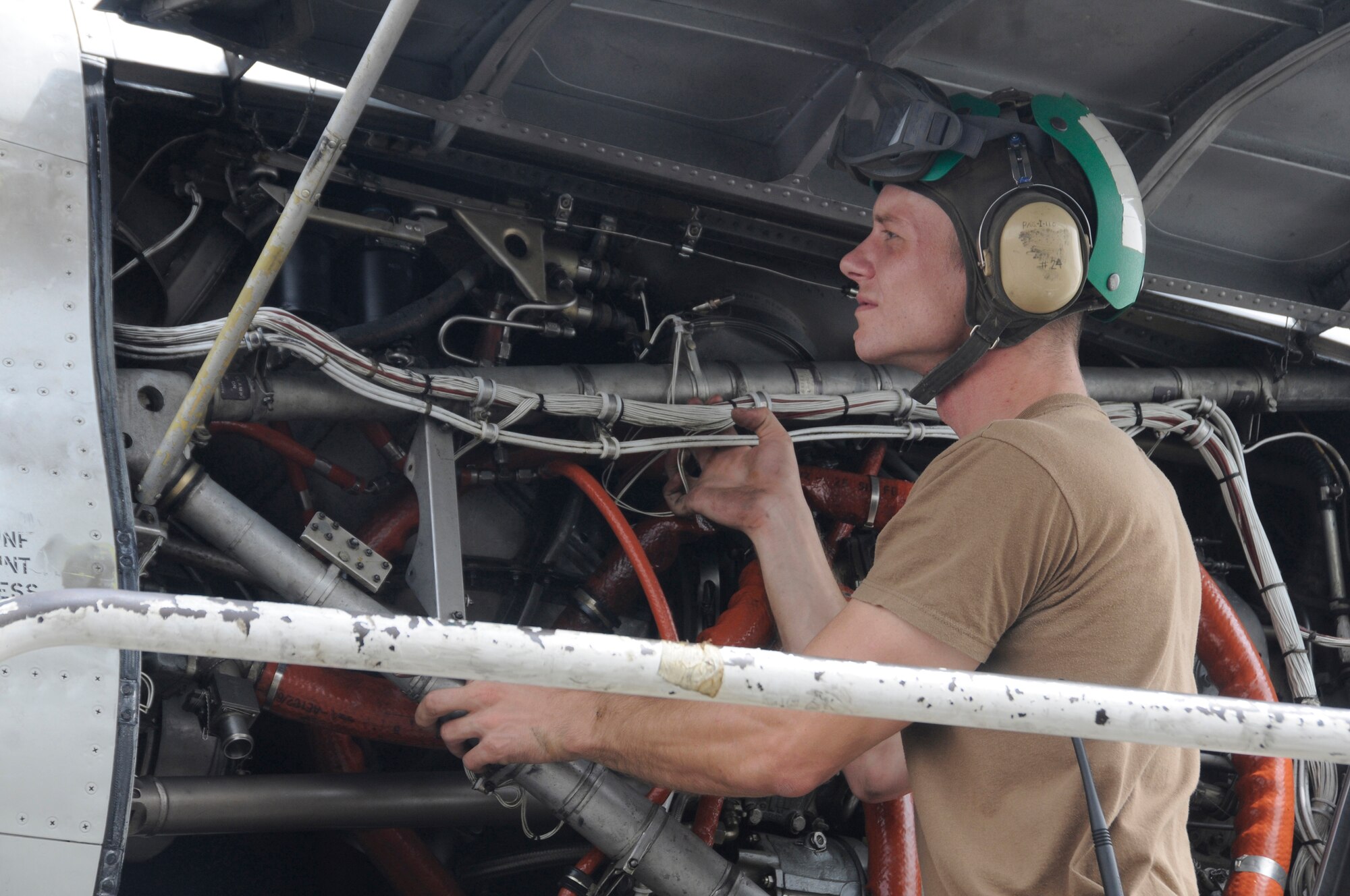 Petty Officer 2nd Class Kevin Leonard, aviation structural mechanic, checks the T56A-14 turboprop engine on a P-3C Orion aircraft to ensure that it is clear of debris Sept. 9, 2008, at an undisclosed air base in Southwest Asia. The P-3 aircraft provides surveillance of the battlespace, either at sea or over land. Its long range and long loiter time have proved invaluable assets during Operations Iraqi and Enduring Freedom as it can view the battlespace and instantaneously provide that information to ground troops, especially U.S. Marines. Petty Officer Leonard, a native of Polk City, Iowa, is deployed from Naval Air Station Whidbey Island, Wash. (U.S. Air Force photo by Staff Sgt. Darnell T. Cannady/Released)