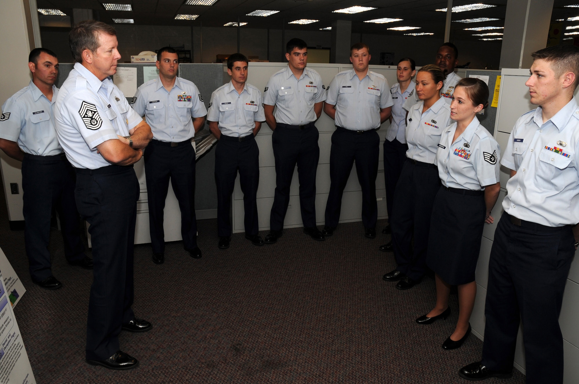 Staff Sgt. Shanna Anderson (second from right) briefs Chief Master Sgt. of the Air Force Rodney J. McKinley during his visit Sept. 8 at Wright-Patterson Air Force Base, Ohio. During his visit, the chief visited with enlisted, officer and civilian employees and answered questions from Airmen. He is the 15th chief master sergeant of the Air Force. Sergeant Anderson is assigned to the National Air and Space Intelligence Center. (U.S. Air Force photo/Staff Sgt. Joshua Strang) 
