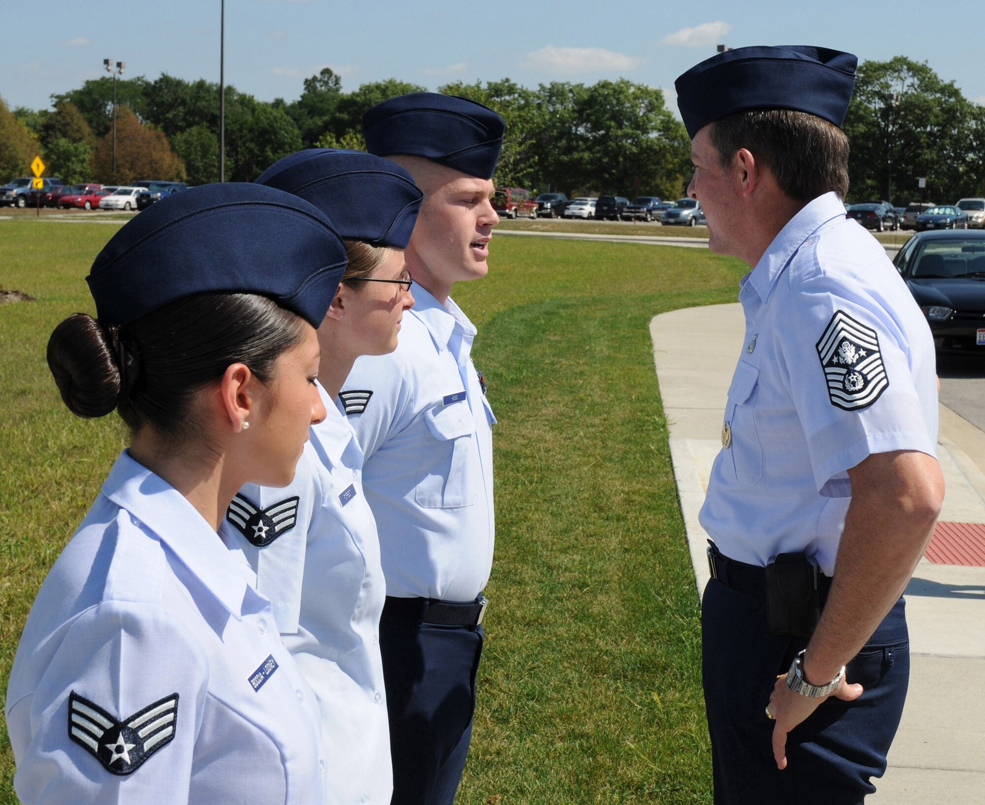 Chief Master Sgt. of the Air Force Rodney J. McKinley is greeted by three Airmen from the National Air and Space Intelligence Center during his Sept. 8 visit to Wright-Patterson Air Force Base, Ohio. The Airmen are Senior Airmen Felicia Boccia-Looney (from left), Kara Forrest and Gregory Hess. They were chosen to greet the chief as recent deployment returnees. During his visit, the chief visited with enlisted, officer and civilian employees and answered questions from Airmen. He is the 15th chief master sergeant of the Air Force. (U.S. Air Force photo/Staff Sgt. Joshua Strang) 
