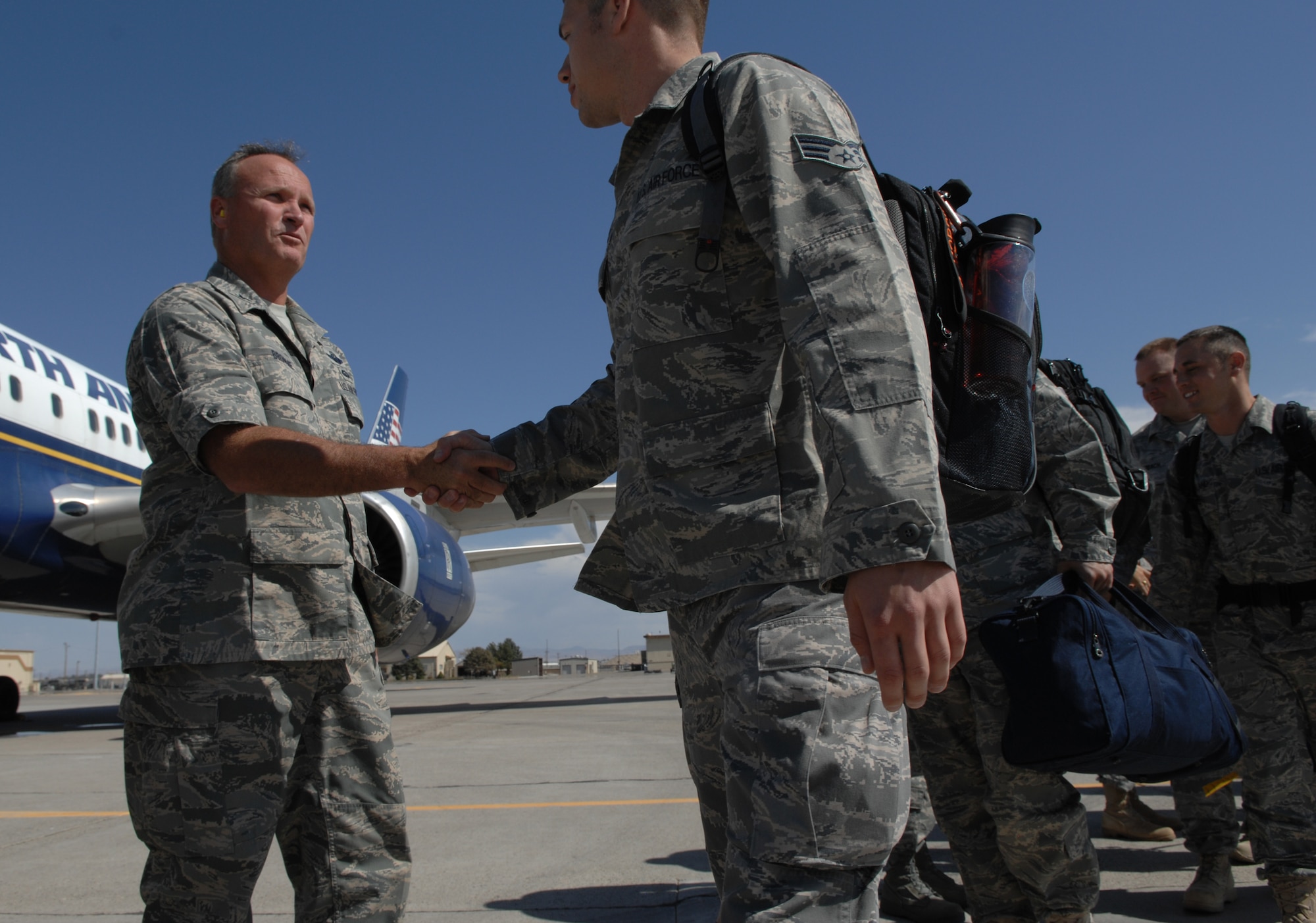 MOUNTAIN HOME AIR FORCE BASE, Idaho --Col. James Browne, 366th Fighter Wing commander, shakes hands with Airmen as they board their plane to deploy. Approximately 140 Airman from the 726th Air Control Squadron and more than 40 members of the Puerto Rico and Oregon Air National Guards deployed to Southwest Asia Sept. 9 in support of Operation Iraqi Freedom. (U.S. Air Force photo/ Airman 1st Class Renishia Richardson)