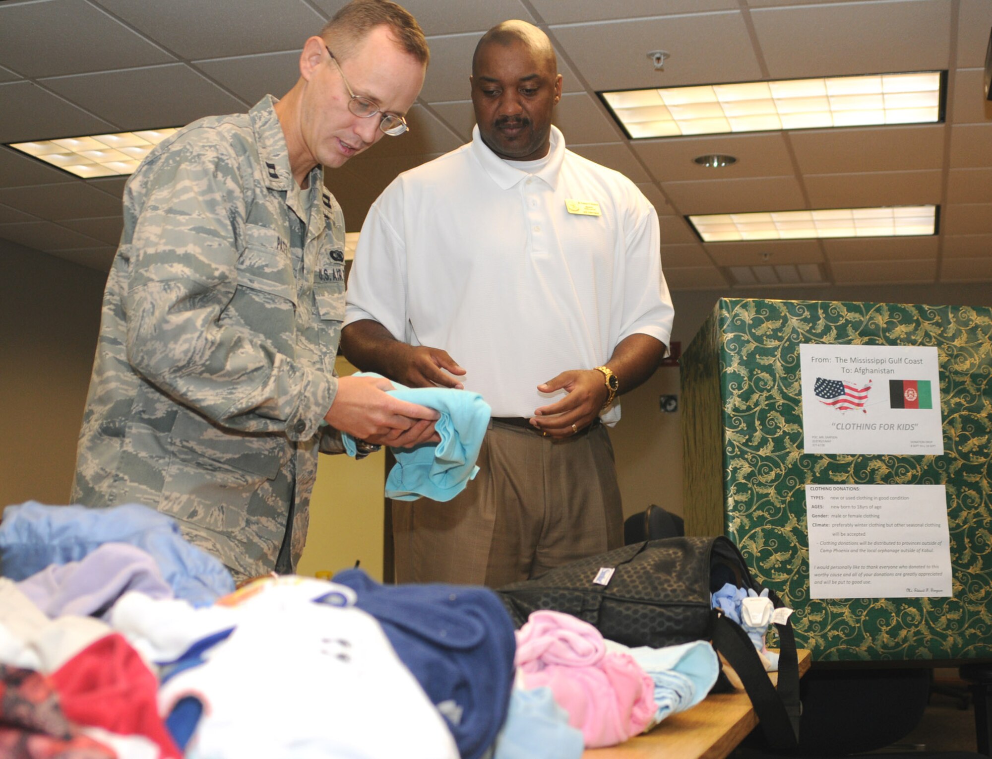 Capt. Robert Patt and Ed Simpson, 333rd TRS, sort clothing donations.  (U.S. Air Force photo by Kemberly Groue)