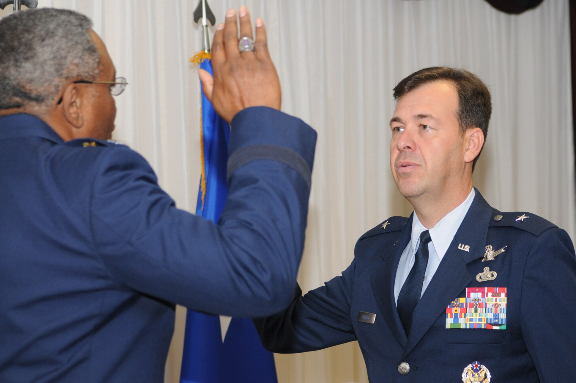 Maj. Gen. Al Flowers, 2nd Air Force commander, administers the oath of office promoting Brig. Gen. Greg Touhill, 81st Training Wing commander, to his new rank during a formal ceremony Friday.  Sept. 2 was General Touhill’s date of rank, but the formal ceremony was pushed back because of Hurricane Gustav.  (U.S. Air Force photo by Kemberly Groue)