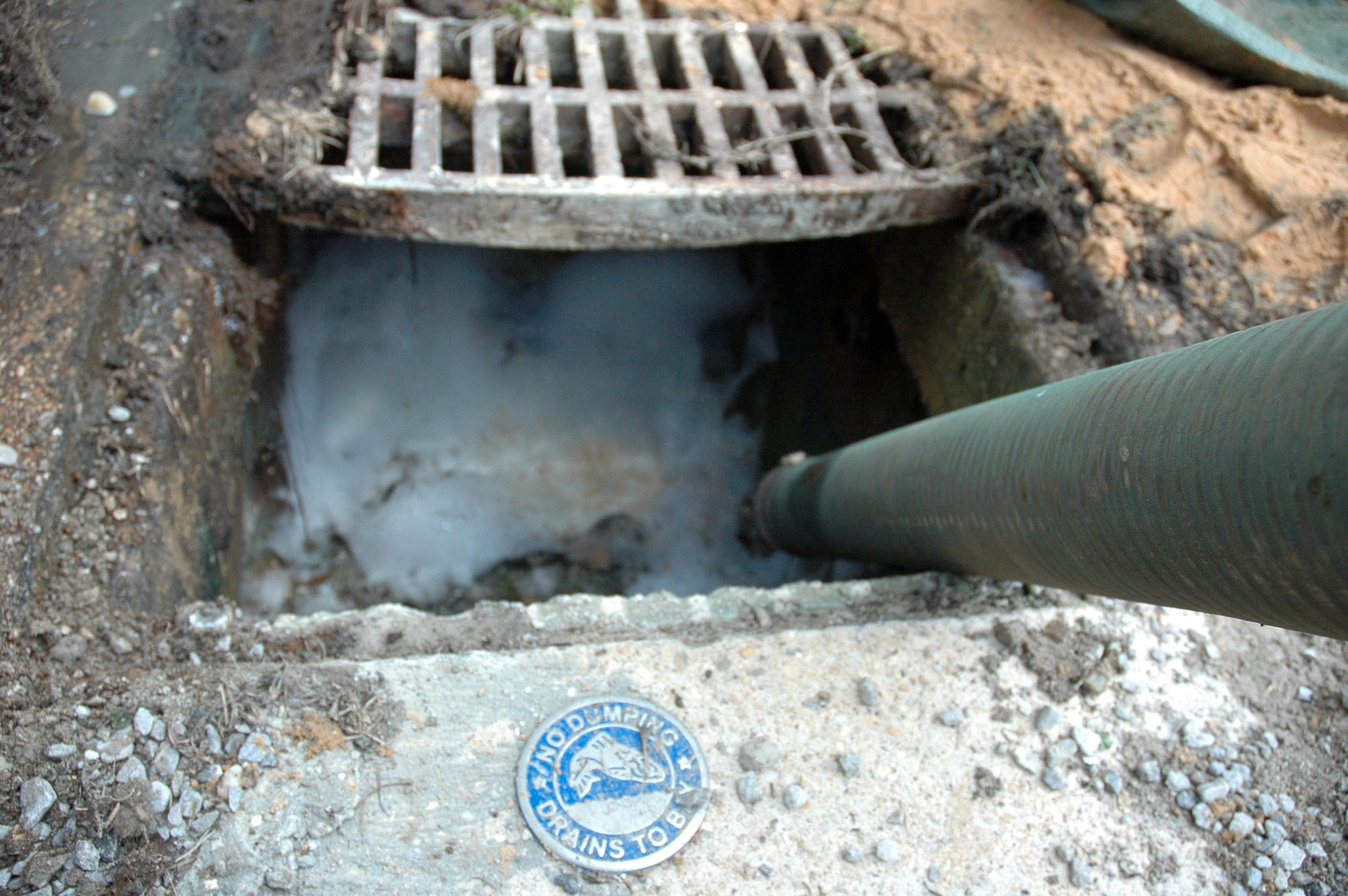 EGLIN AIR FORCE BASE, Fla. -- 796th Civil Engineer Squadron, Utilities Maintenance drains a sewer in front of hangar 71 of foam that spilled into a drainage system. It was vital that the incident be resolved because the sewers drain into the bay, endangering the wildlife in the waters. The cause of the incident is currently under investigation. (US Air Force photo/ Airman 1st Class Anthony Jennings)