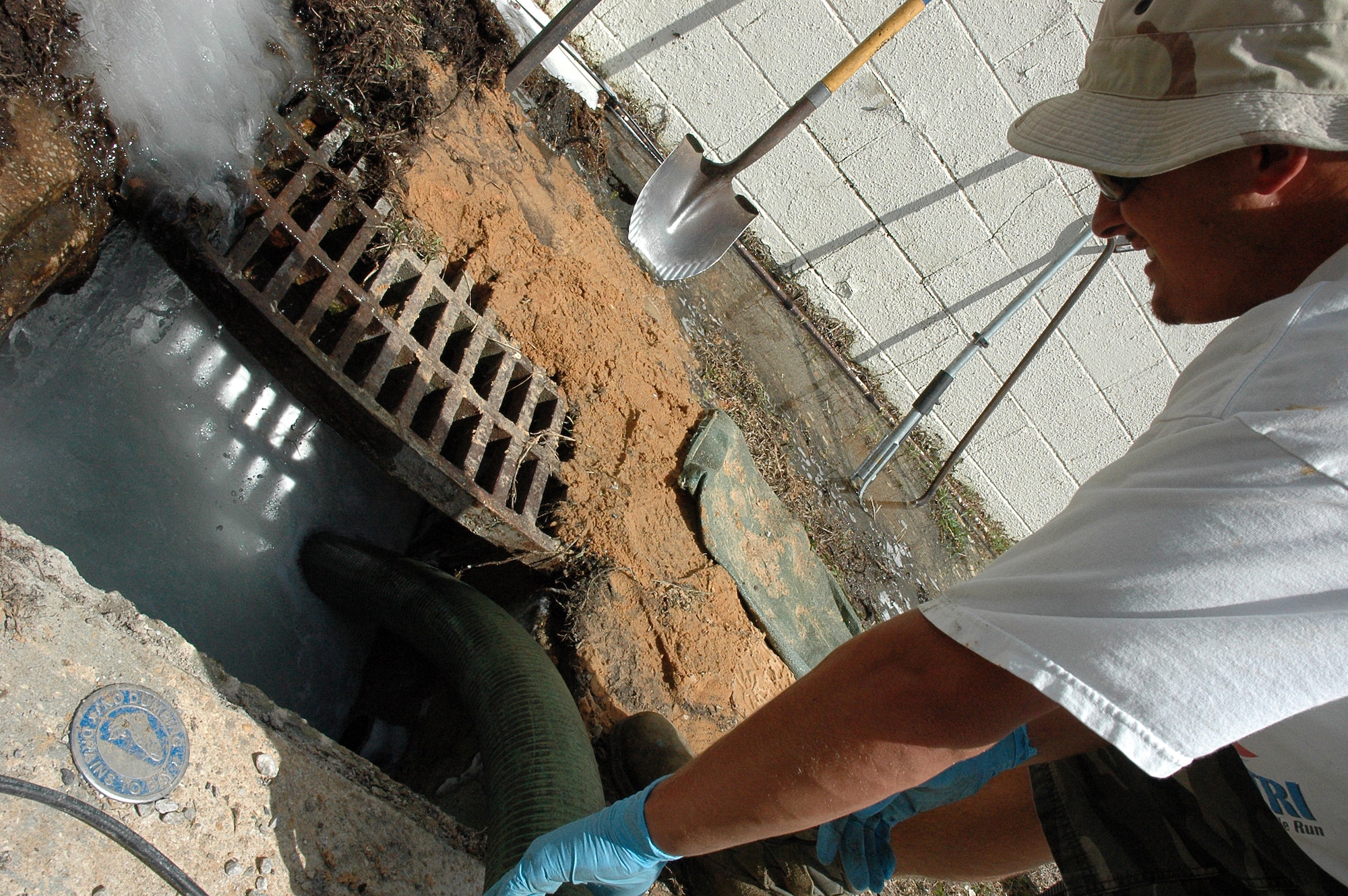 EGLIN AIR FORCE BASE, Fla. -- 796th Civil Engineer Squadron, Utilities Maintenance drains a sewer in front of hangar 71 of foam that spilled into a drainage system. It was vital that the incident be resolved because the sewers drain into the bay, endangering the wildlife in the waters. The cause of the incident is currently under investigation. (US Air Force photo/ Airman 1st Class Anthony Jennings