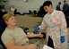 Staff Sgt. Kristen Marfa, 1st Aerospace Medical Squadron, Bioenvironmental Engineering non-commissioned officer in charge, donates blood for the blood drive at the Langley Community Center.  Sunee Marshall, civilian contractor from Naval Medical Center Portsmouth, draws blood from volunteers during the Armed Services Blood Drive here Sept. 9.  Sergeant Marfa was one of 71 donors at this drive. (U.S. Air Force photo/Tech. Sgt. Levi Collins) 