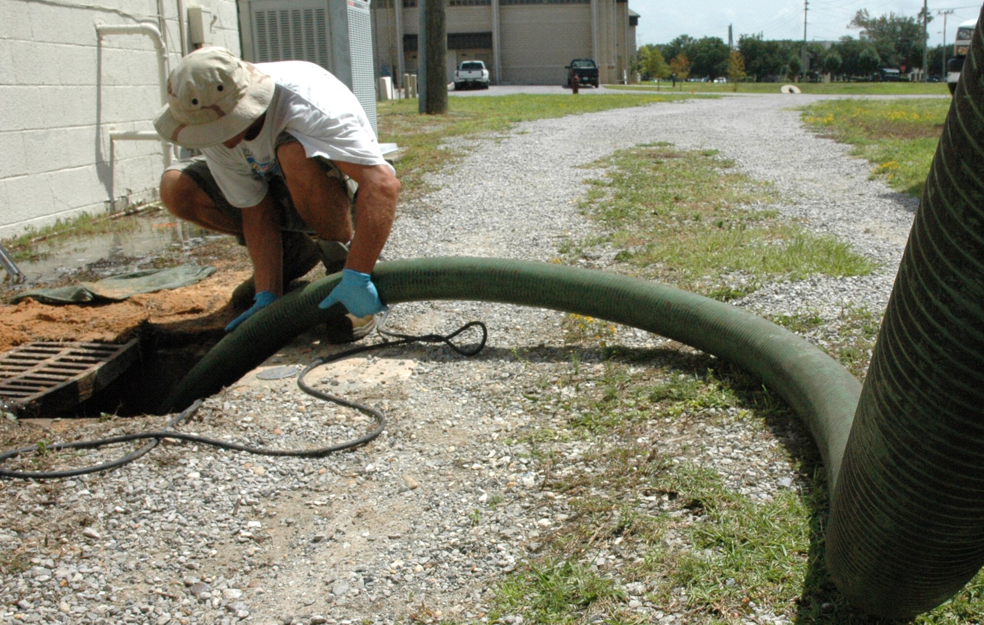 EGLIN AIR FORCE BASE, Fla. -- 796th Civil Engineer Squadron, Utilities Maintenance drains a sewer in front of hangar 71 of foam that spilled into a drainage system. It was vital that the incident be resolved because the sewers drain into the bay, endangering the wildlife in the waters. The cause of the incident is currently under investigation. (US Air Force Photo/ Airman 1st Class Anthony Jennings)