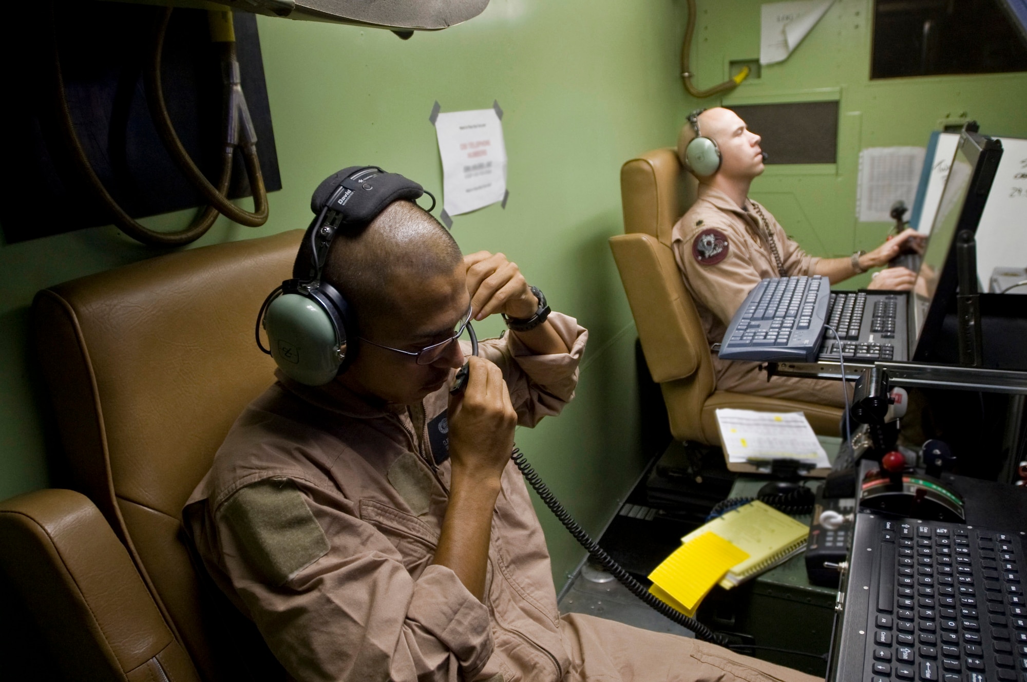 Lt. Col. Geoffrey Barnes and Senior Airman Claudio Vela Jr. prepare to land an MQ-1 Predator unmanned aircraft system from a nearby control room Sept. 3 at Ali Base, Iraq. Colonel Barnes and Airman Vela are deployed from Creech Air Force Base, Nev., and are assigned to the assigned to the 46th Expeditionary Reconnaissance and Attack Squadron Det. 1. The Predator is a medium-altitude, long-endurance, remotely piloted aircraft. Its mission here is to interdict and conduct armed reconnaissance against critical and perishable targets in support of the war on terrorism. (U.S. Air Force photo/Airman 1st Class Christopher Griffin) 
