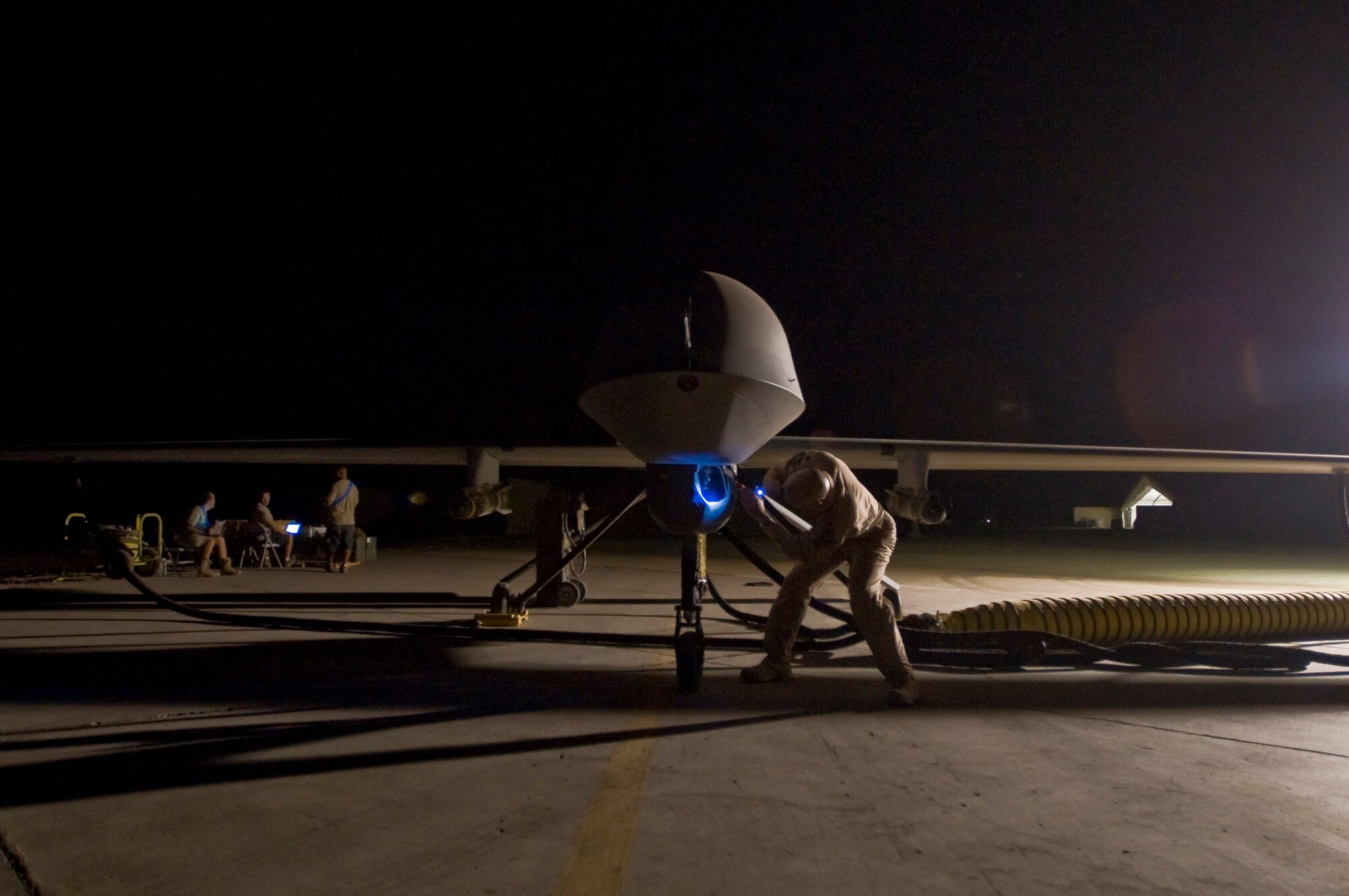 Lt. Col. Geoffrey Barnes performs a preflight inspection of an MQ-1 Predator unmanned aircraft system Sept. 3 at Ali Base, Iraq. The Predator is a medium-altitude, long-endurance, remotely piloted aircraft system. Colonel Barnes is commander of the 46th Expeditionary Reconnaissance and Attack Squadron Det. 1, and is deployed from Creech Air Force Base, Nev. (U.S. Air Force photo/Airman 1st Class Christopher Griffin) 
