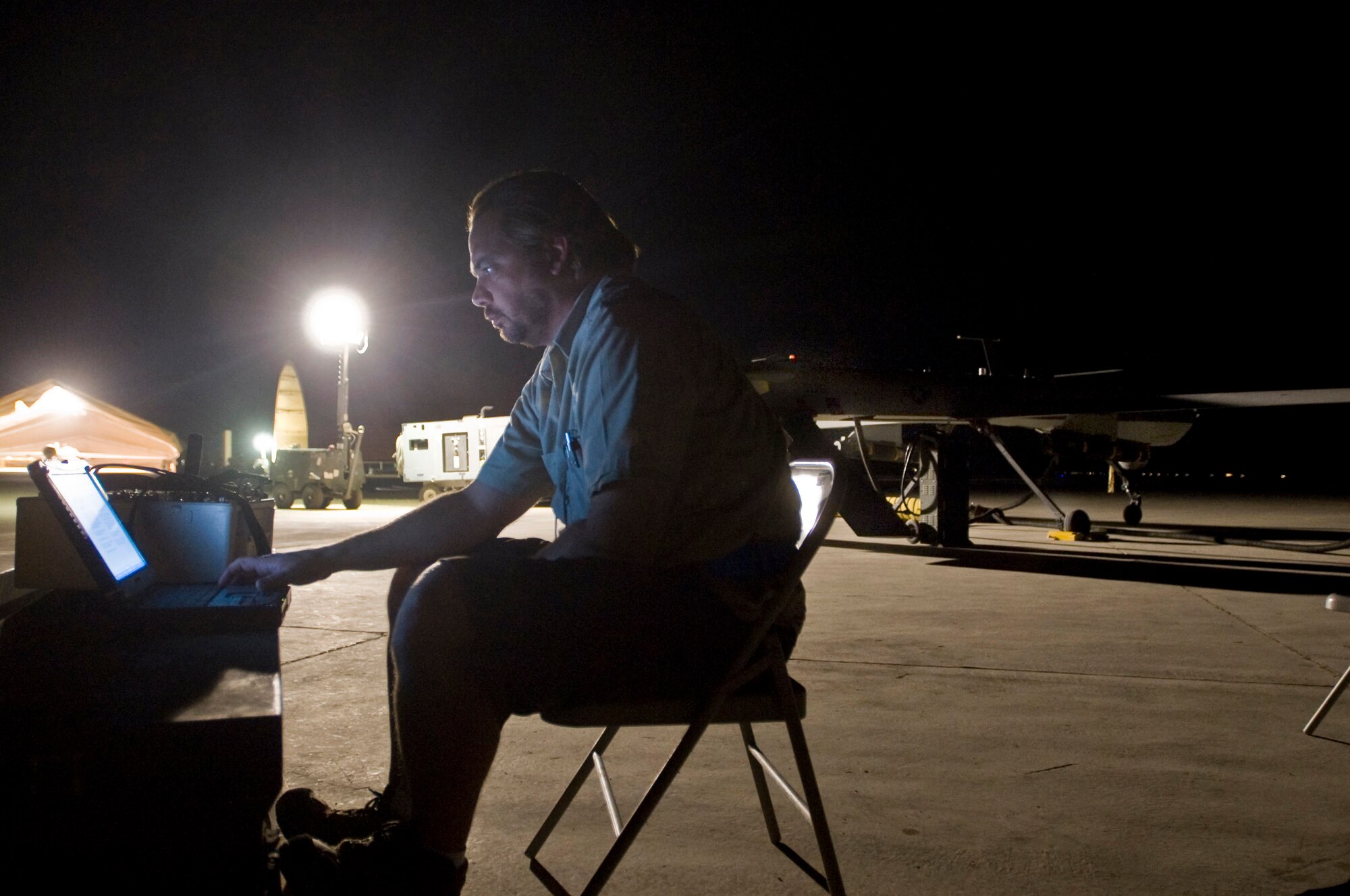 Troy Schossow reads over revised technical guidelines for the MQ-1 Predator Sept. 3 at Ali Base, Iraq. Through the use of advanced capabilities, focused doctrine and detailed training, the Predator provides integrated and synchronized close air combat operations, to include intelligence, surveillance and reconnaissance. Mr. Schossow is assigned to the 46th Expeditionary Reconnaissance and Attack Squadron Det. 1. (U.S. Air Force photo/Airman 1st Class Christopher Griffin) 
