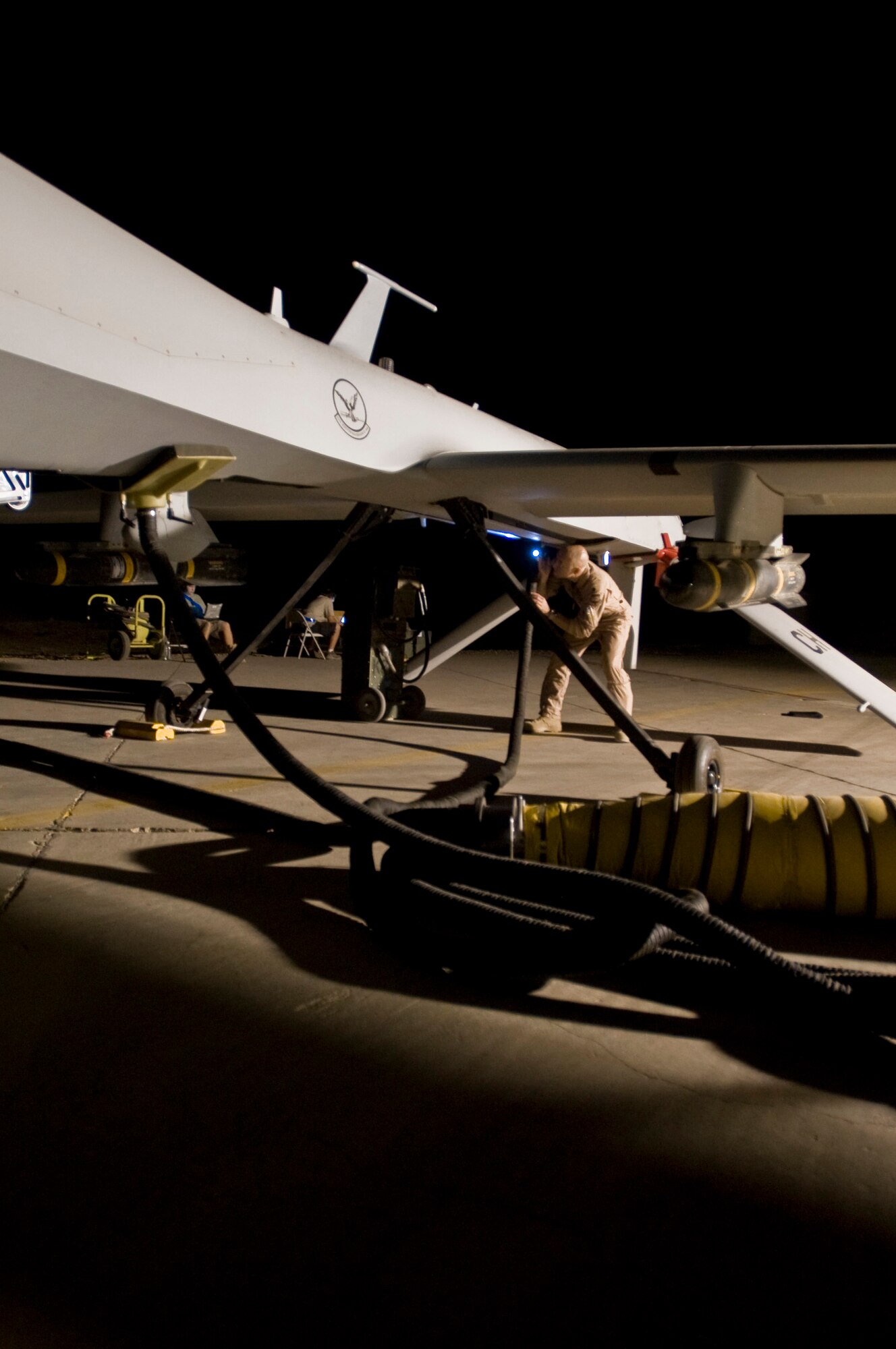 Lt. Col. Geoffrey Barnes performs a preflight inspection of an MQ-1 Predator unmanned aircraft system Sept. 3 at Ali Base, Iraq. The Predator is a medium-altitude, long-endurance, remotely piloted aircraft system. Colonel Barnes is commander of the 46th Expeditionary Reconnaissance and Attack Squadron Det. 1, and is deployed from Creech Air Force Base, Nev. (U.S. Air Force photo/Airman 1st Class Christopher Griffin) 
