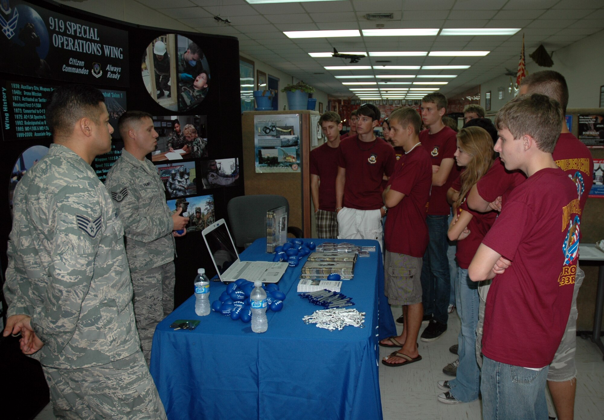 Staff Sergeants Angel Velasquez (far left) and Brian Paavo (left), 919 Special Operations Wing recruiters, explain the many career and educational possibilities available in the Air Force Reserve to ROTC cadets from Niceville High School. The 919th SOW hosted a tour of the base for more than 70 high school seniors in ROTC from three local schools. The cadets' tour gave them an inside look into maintenance and flying functions of the wing. (US Air Force Photo/Senior Airman Jon McCallum) 