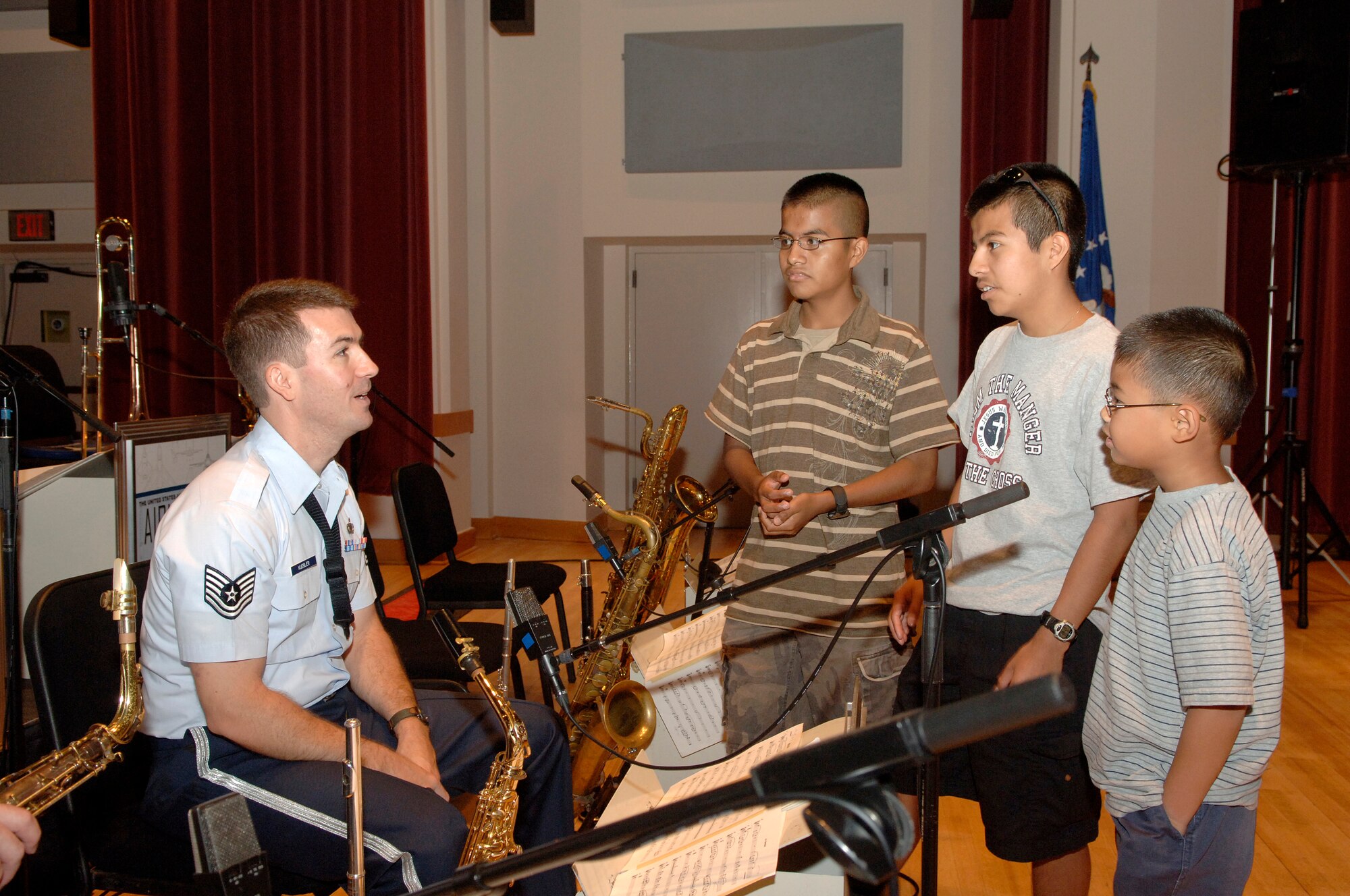 Home-school students Daniel, Luis, and Shawn Boothe talk to Tech. Sgt. Tyler Kuebler, U.S. Air Force Band Airmen of Note, Sept. 5 after a recording session featuring recording artist Kurt Elling. Home-school communities from Fort Meade, Md., Fort Belvoir, Va., Andrews AFB, Md., and Bolling gathered in Gabriel Hall Friday to be part of the Air Force Band’s 2008 Jazz Heritage Series. (U.S. Air Force photo by Thomas Dennis)