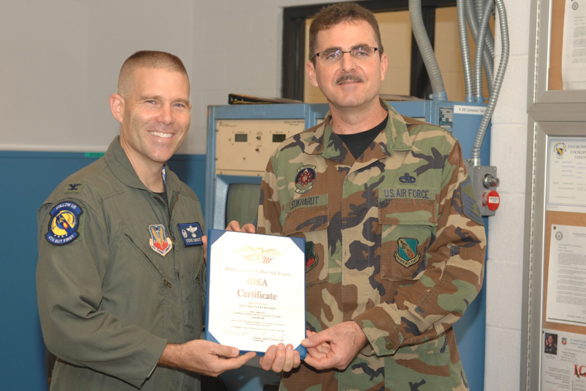Colonel Steve Kwast, 4th Fighter Wing commander, presents Master Sgt. Kevin Leukhardt, 4th Component Maintenance Squadron,with a certificate of appreciation for coming up with an idea that will save the Air Force roughly $8 million Aug. 27, 2008, on Seymour Johnson Air Force Base, N.C. Sergeant Leukhardt recieved a check for $10,000 through the IDEA Program, which rewards innovation.  (U.S. Air Force photo by Airman 1st Class Gino Reyes) 