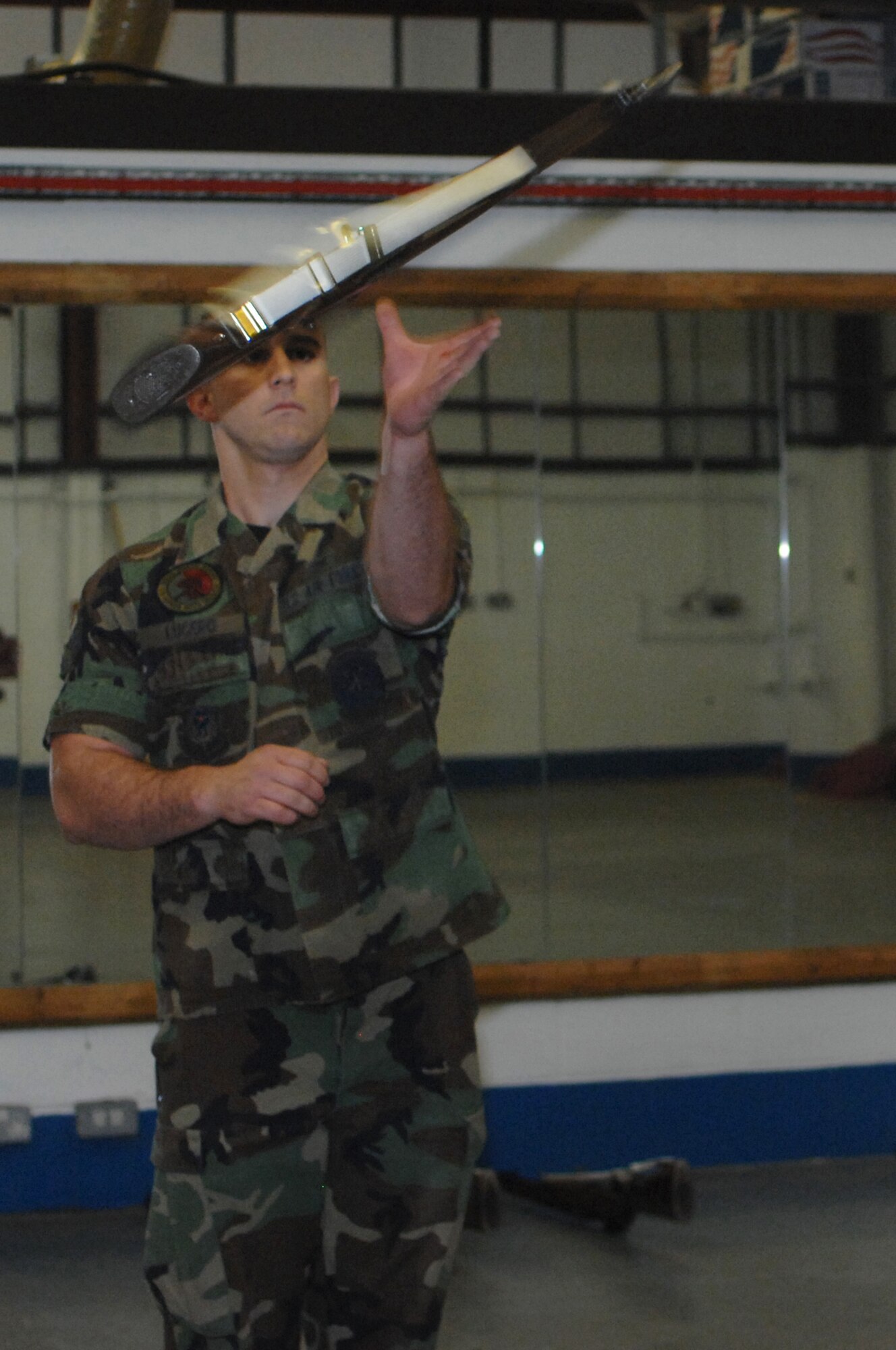 Senior Airman Joshua Lucero, 352nd Maintenance Squadron, catches a rife during the Team Mildenhall Honor Guard’s weekly practice Sept. 3, 2008.  The honor guard honors those who retire, posts colors for changes of command and participates in parades and special events. (U.S. Air Force photo by Senior Airman Teresa M. Hawkins)