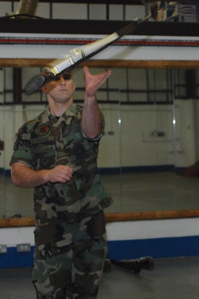 Senior Airman Joshua Lucero, 352nd Maintenance Squadron, catches a rife during the Team Mildenhall Honor Guard’s weekly practice Sept. 3, 2008.  The honor guard honors those who retire, posts colors for changes of command and participates in parades and special events. (U.S. Air Force photo by Senior Airman Teresa M. Hawkins)