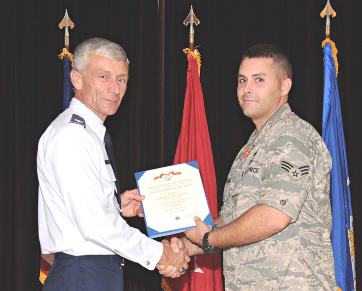 Senior Airman Benjamin McCullough, 39th Civil Engineer Squadron Explosive Ordnance Disposal journeyman, is presented the Air Force Combat Action Medal Aug. 29 during the base-wide enlisted promotion ceremony. Airman McCullough earned the medal for being part of combat actions while deployed to Iraq in September, 2007. (U.S. Air Force photo by Airman 1st Class Amber Russell)