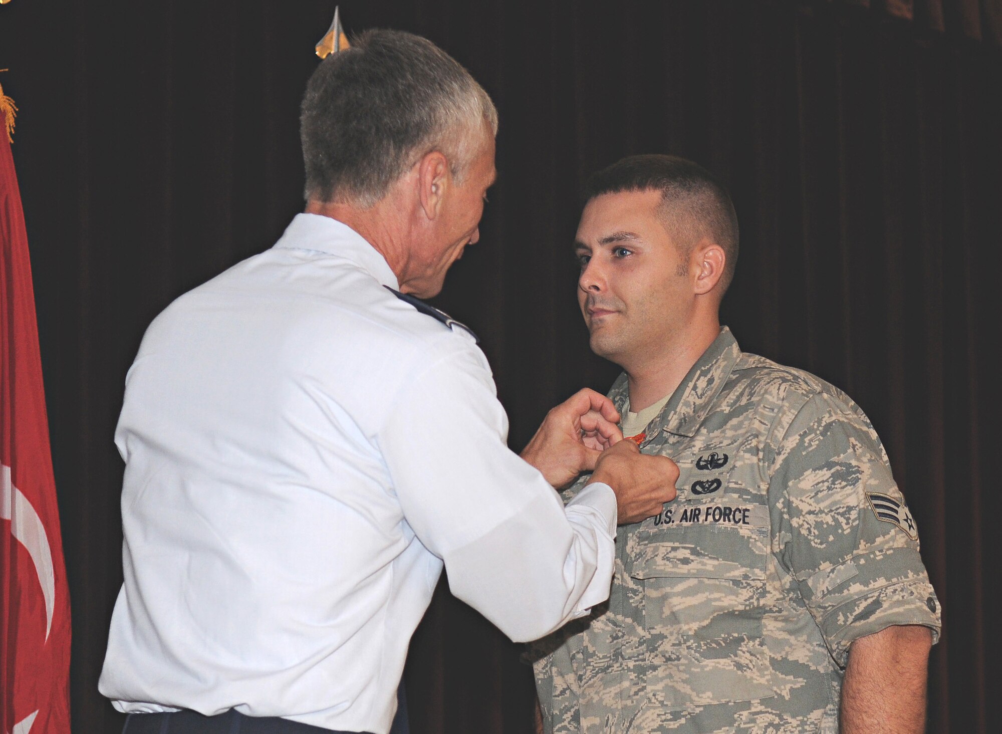 Senior Airman Benjamin McCullough, 39th Civil Engineer Squadron Explosive Ordnance Disposal journeyman, is presented the Air Force Combat Action Medal Aug. 29 during the base-wide enlisted promotion ceremony. Airman McCullough earned the medal for being part of combat actions while deployed to Iraq in September, 2007. (U.S. Air Force photo by Airman 1st Class Amber Russell)