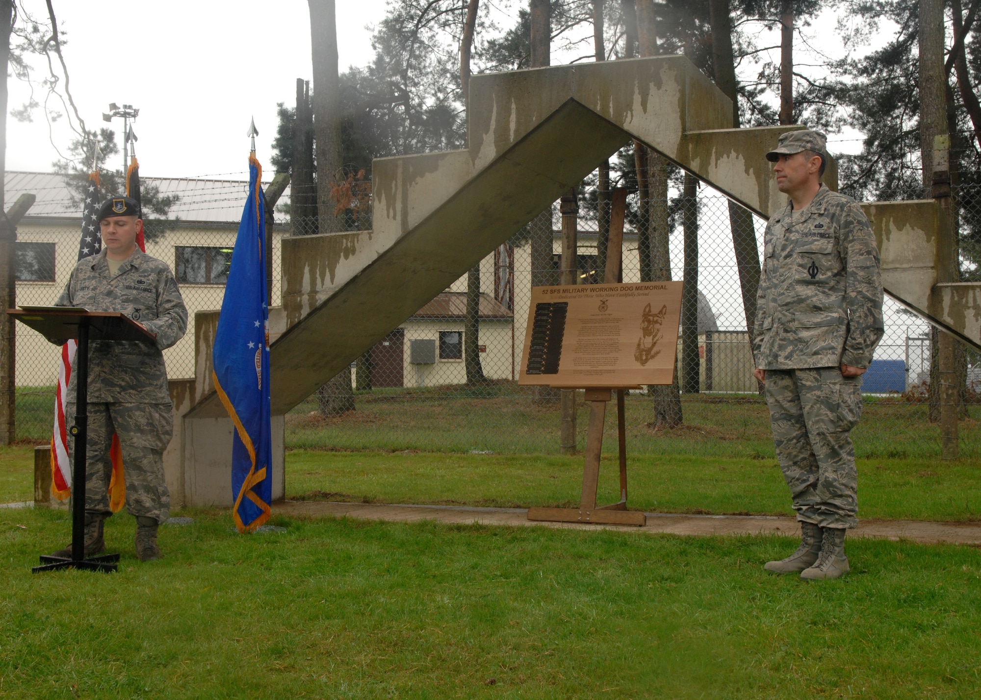 SPANGDAHLEM AIR BASE, Germany -- Staff Sgt. David Duty, 52nd Security Forces Squadron, reads off the names of the Military Working Dogs that have retired from service or passed away while still on duty during an MWD Memorial, Sept 3, 2008. Col. William Nadolski, 52nd Mission Support Group commander, was a distinguished guest at the memorial and unveiled the memorial plaque. The memorial displays the names and tattoo numbers of MWDs that have valiantly served. (U.S. Air Force photo by Airman Staci Miller)