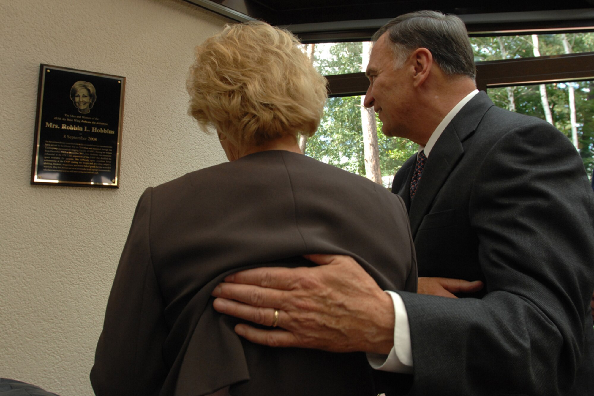 Mrs. Robbin Hobbins (left) and retired Air Force General Tom Hobbins admire the plaque hung in the Contigency Aeromedical Staging Facility United Service Organization (USO) atrium, which was dedicated to her on Sept. 8, 2008, Ramstein Air Base, Germany.  The 435th Medical Group dedicated the CASF USO atrium to Mrs. Robbin Hobbins for her devotion in making the life of wounded warriors more comfortable. (U.S. Air Force photo by Senior Airman Amber Bressler)(Released)