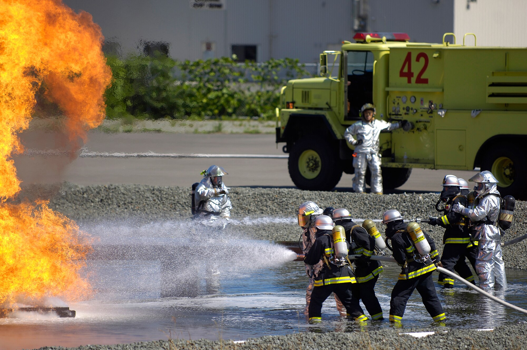 MISAWA AIR BASE, Japan -- Misawa firefighter crew chiefs, Shuji Imota and Hitoshi Kashiwazaki, instruct Towada City firefighters on how to correctly extinguish a downed aircraft in case of an off base crash here Sept. 10, 2008. The training is conducted annually.  (U.S. Air Force photo by Senior Airman Chad Strohmeyer)