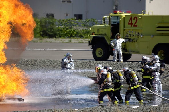 MISAWA AIR BASE, Japan -- Misawa firefighter crew chiefs, Shuji Imota and Hitoshi Kashiwazaki, instruct Towada City firefighters on how to correctly extinguish a downed aircraft in case of an off-base crash Sept. 10. The training is conducted annually. (U.S. Air Force photo by Senior Airman Chad Strohmeyer) 