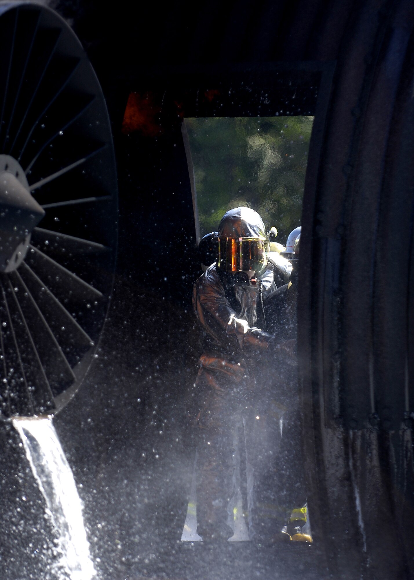 MISAWA AIR BASE, Japan -- Shuji Imota, 35th Civil Engineer Squadron, firefighter crew chief, instructs Towada City firefighters inside a burning aircraft during a simulated crash here Sept. 10, 2008. The training was conducted in order to acquaint Towada City firefighters with Air Force training in case of a crash off base.  (U.S. Air Force photo by Senior Airman Chad Strohmeyer)