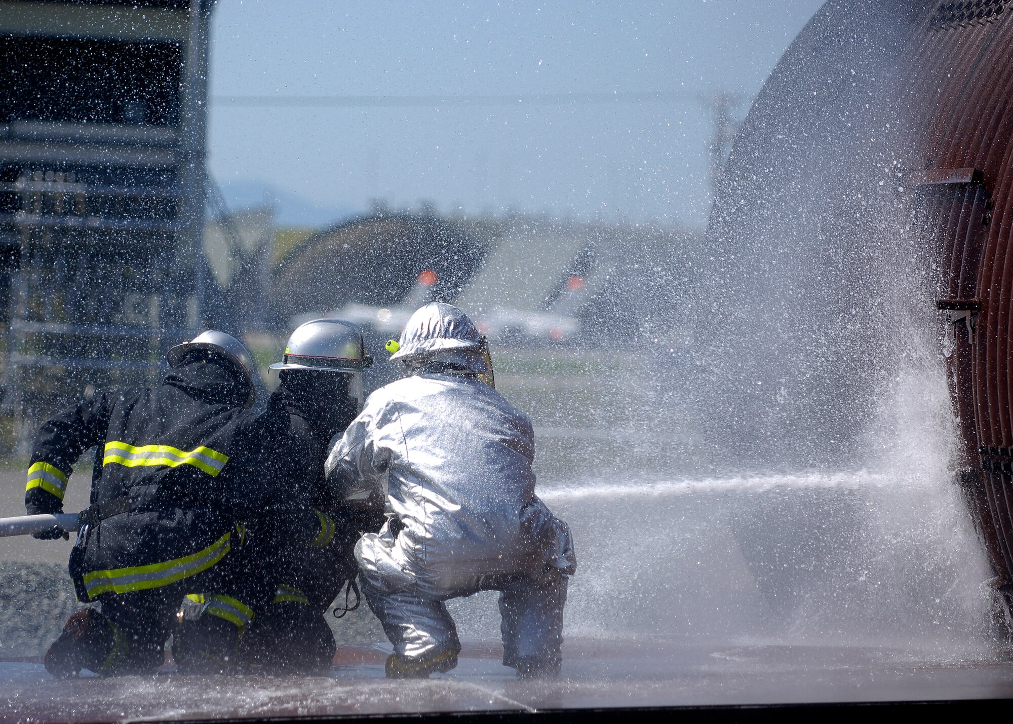 MISAWA AIR BASE, Japan -- Shuji Imota, 35th Civil Engineer Squadron, firefighter crew chief, instructs Towada City firefighters on how to extinguish a burning aircraft during a simulated crash here Sept. 10, 2008. The training was conducted in order to acquaint Towada City firefighters with Air Force training in case of a crash off base.  (U.S. Air Force photo by Senior Airman Chad Strohmeyer)