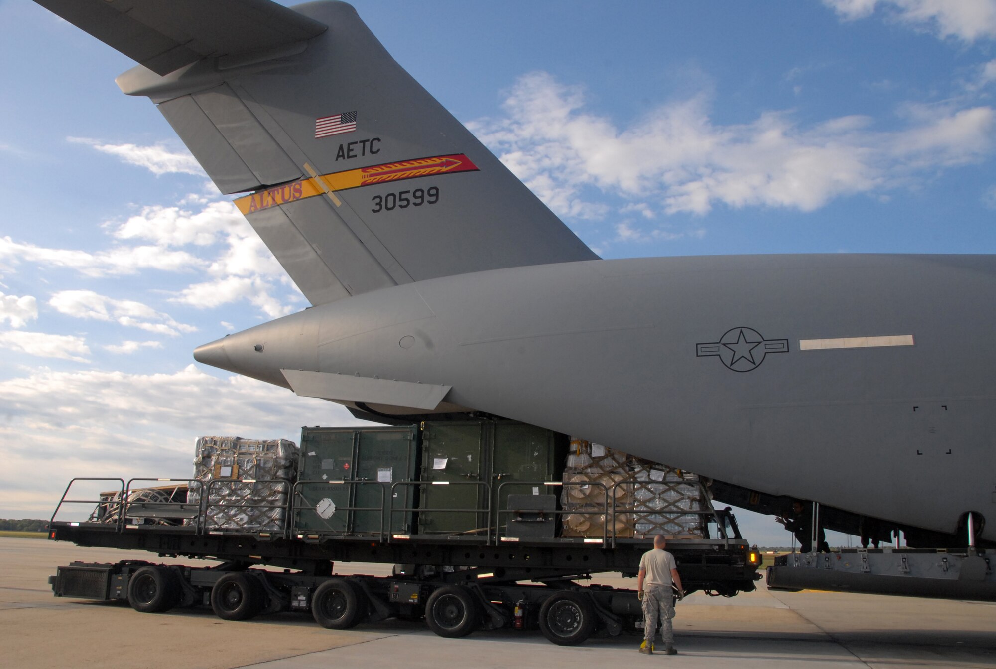 An Airman from the 305th Aerial Port Squadron, McGuire Air Force Base, N.J., helps load a C-17 Globemaster III flown by a crew assigned to the 58th Airlift Squadron, Altus AFB, Okla., Sept. 10. The cargo uploaded belongs to the 617th Contingency Response Group, McGuire AFB N.J. The supplies will be used for emergency response and contingencies related to Hurricane Ike, and were flown to Harlingen, Texas. (U.S. Air Force photo/Airman 1st Class Cherice I. Bryant)
