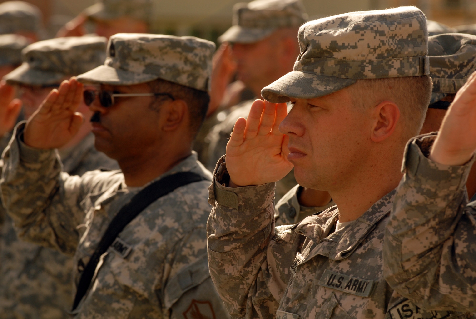 BAGRAM AIR FIELD, Afghanistan (Sept. 11, 2008) -- Soldiers salute during the 9/11 ceremony held on Bagram Air Field Thursday.  Troops from Coalition and International Security Assistance Forces gathered to pay their respect and remember those who were killed seven years ago.  (U.S. Army photo by Spc. Scott Davis)