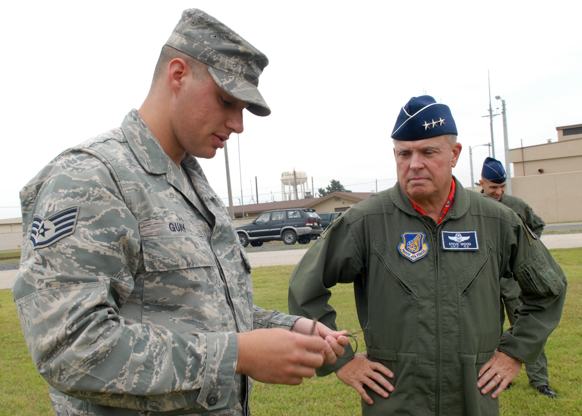Staff Sgt. Dennis R. Guay, an explosive ordnance disposal craftsman with 8th Civil Engineer Squadron briefs Lt. Gen. Stephen Wood, 7th Air Force commander, on EOD capabilities here Sept 11. Staff Sgt. Guay is the Pacific Air Forces nominee for the Lance P. Sijan Leadership Award. (US Air Force photo by Senior Airman Angela Ruiz)