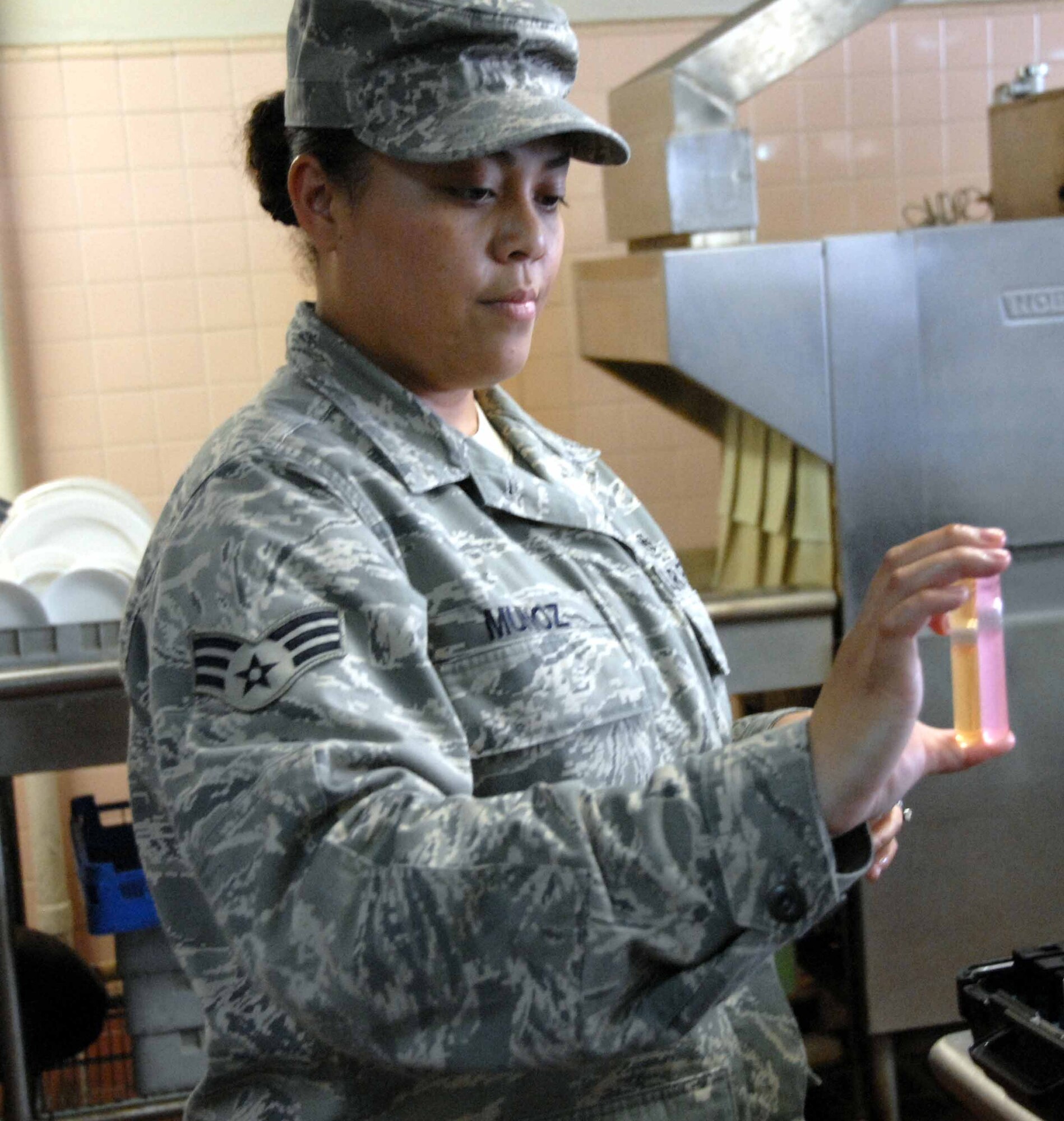 OSAN AIR BASE, Republic of Korea -- Senior Airman Verna Munoz, 51st Aerospace Medicine Squadron Bioenvironmental Engineering technician, compares water samples taken at the Challenger Club. The Bioenvironmental Engineering Flight determined that Osan's tap water met all U.S. Environmental Protection Agency and Korean Environmental Governing Standards drinking water health standards, thus it is safe for consumption. (U.S. Air Force photo/Staff Sgt. Candy Knight)