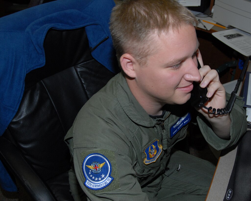 932nd Airlift Wing's Staff Sgt. Kenny Wolf, an aeromedical evacuation technician at the Air Force Reserve Command's Illinois wing at Scott Air Force Base, answers calls and communicates information to fellow Airmen prior to Hurricane IKE approaching the Texas area.  (U.S. Air Force photo by Maj. Stan Paregien)