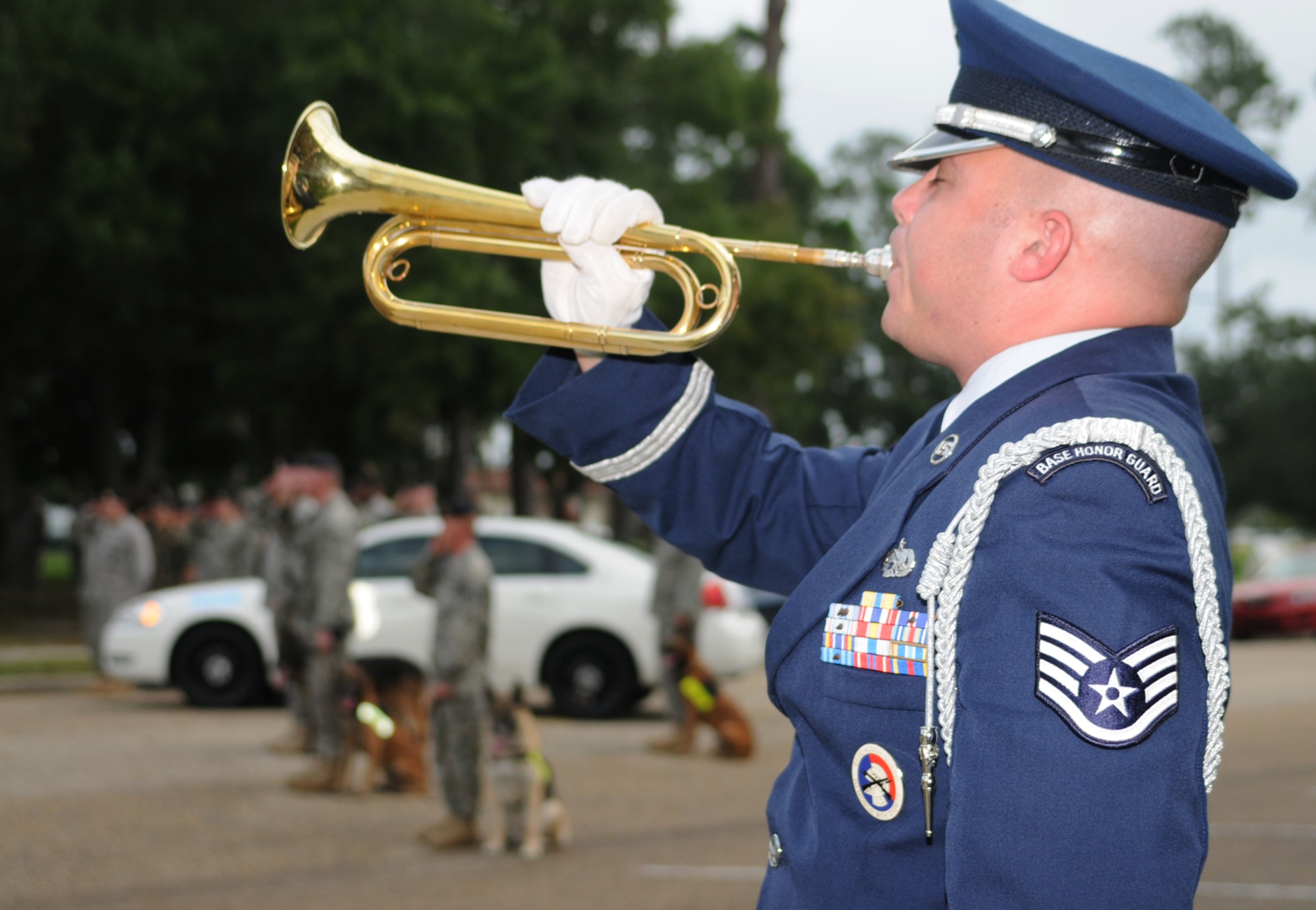 Staff Sgt. Kenneth Parker, 81st Training Wing Honor Guard, plays Taps after the American flag is lowered in a retreat ceremony at Keesler Air Force Base commemorating the tragic events of Sept. 11, 2001.  (U.S. Air Force photo by Kemberly Groue)
