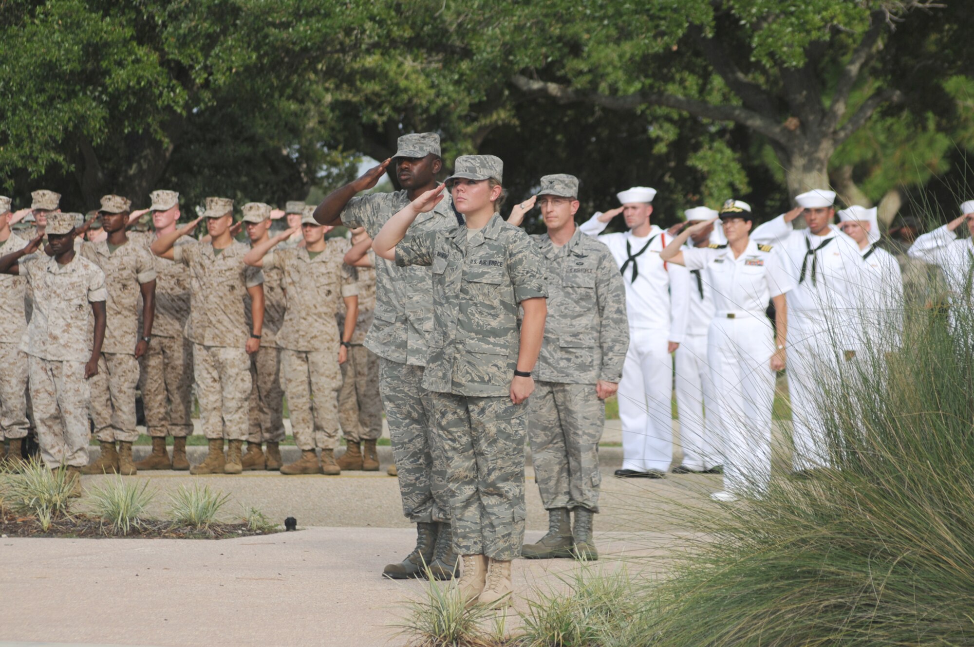 Hundreds of Marines, Sailors, Soldiers and Airmen pay their respects as the flag is lowered on Patriot Day in a retreat ceremony on Keesler Air Force Base.  (U.S. Air Force photo by Kemberly Groue)