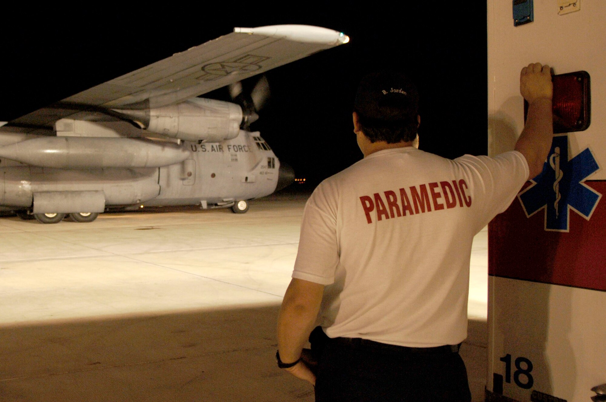 A paramedic watches as a C-130 Hercules from Little Rock Air Force Base, Ark., comes to a stop on the tarmac in Corpus Christi, Texas, Sept. 11. The C-130 arrived at Corpus Christi to transport patients to a safe location out of Hurricane Ike's path. (U.S. Air Force photo/Staff Sgt. Joseph Swafford Jr.)