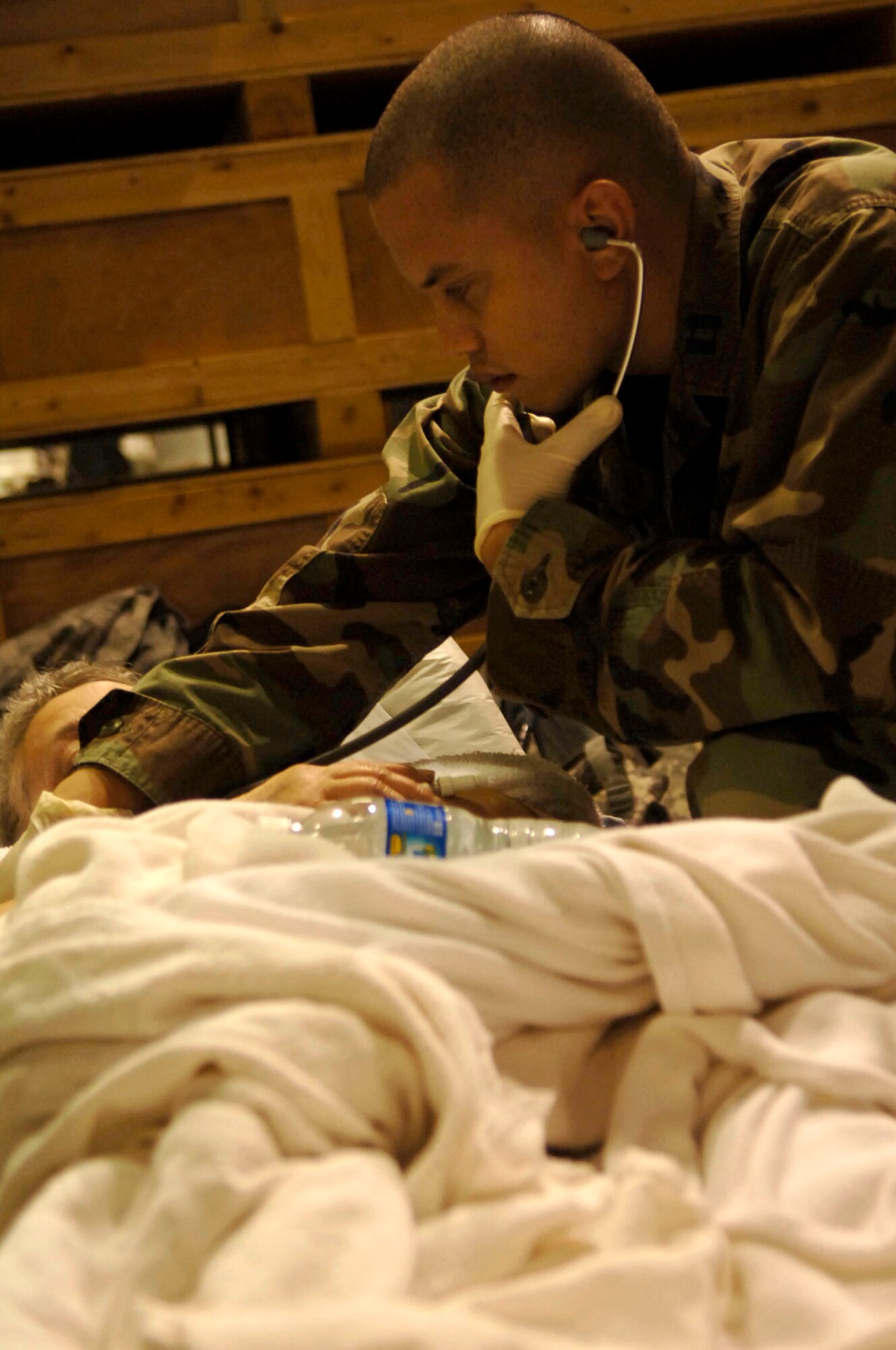 Capt. Alan Delgado tends to a patient waiting for evacuation in Corpus Christi, Texas, Sept. 11. The team is helping evacuate patients from a local area hospital. Air Force aircraft transported patients to safe locations out of Hurricane Ike's path. Captain Delgado is a nurse with a mobile aeromedical staging facility team from MacDill Air Force Base, Fla. (U.S. Air Force photo/Staff Sgt. Joseph Swafford Jr.)