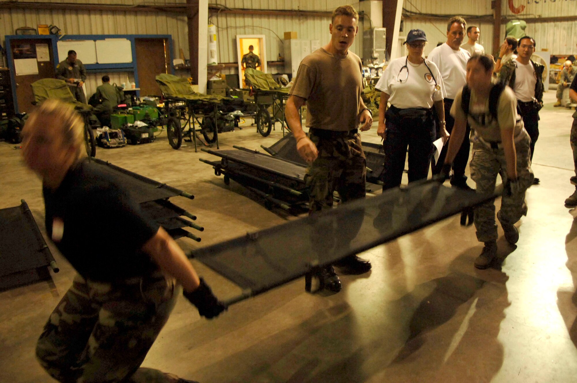 Members of the mobile aeromedical staging facility team from MacDill Air Force Base, Fla., help train a disaster medical assistance team from San Benardino, Calif., on proper litter lifting and carrying techniques. The Air Force MASF team, along with civilian agencies, were deployed to Corpus Christi, Texas, in support of Hurricane Ike evacuation efforts. (U.S. Air Force photo/Staff Sgt. Joseph Swafford Jr.)