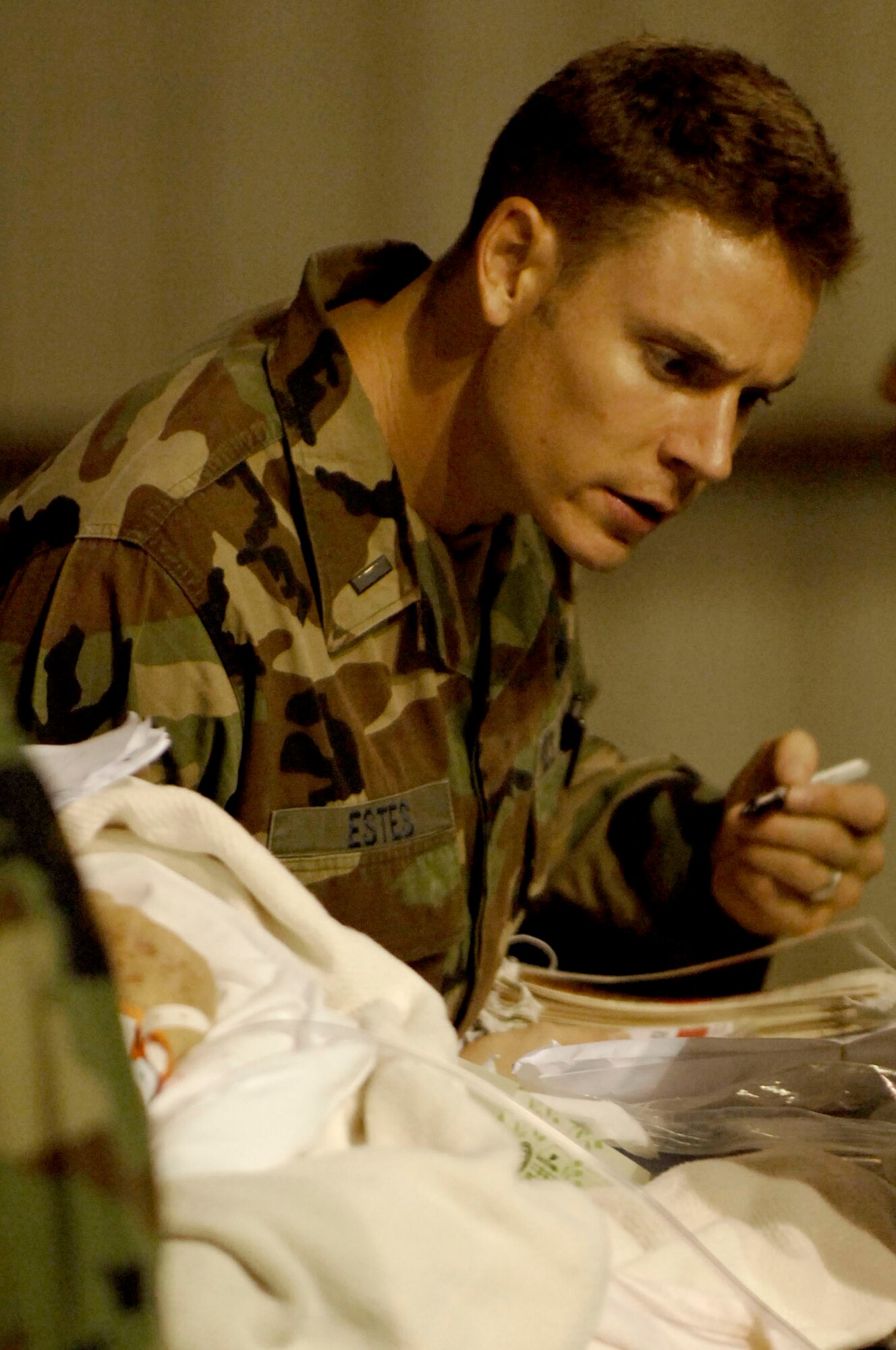 First Lt. Jason Estes tends to a patient waiting for evacuation in Corpus Christi, Texas, Sept. 11. The team is helping to evacuate patients from a local area hospital. Air Force aircraft transported patients to safe locations out of Hurricane Ike's path. Lieutenant Estes is the director of operations for the mobile aeromedical staging facility team from MacDill Air Force Base, Fla. (U.S. Air Force photo/Staff Sgt. Joseph Swafford Jr.)