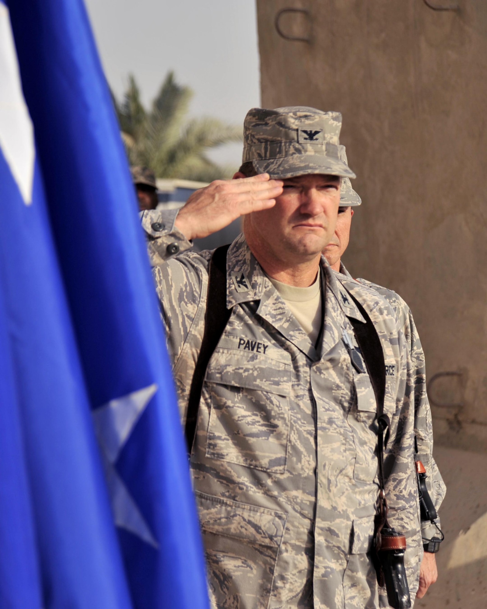 Col. David Pavey salutes during the national anthem at a ceremony marking the seven-year anniversary of the terrorist attacks of Sept. 11, 2001, Sept. 11 at Sather Air Base, Iraq. Colonel Pavey is the 447th Air Expeditionary Group commander. (U.S. Air Force photo/Master Sgt. Brian Davidson) 
