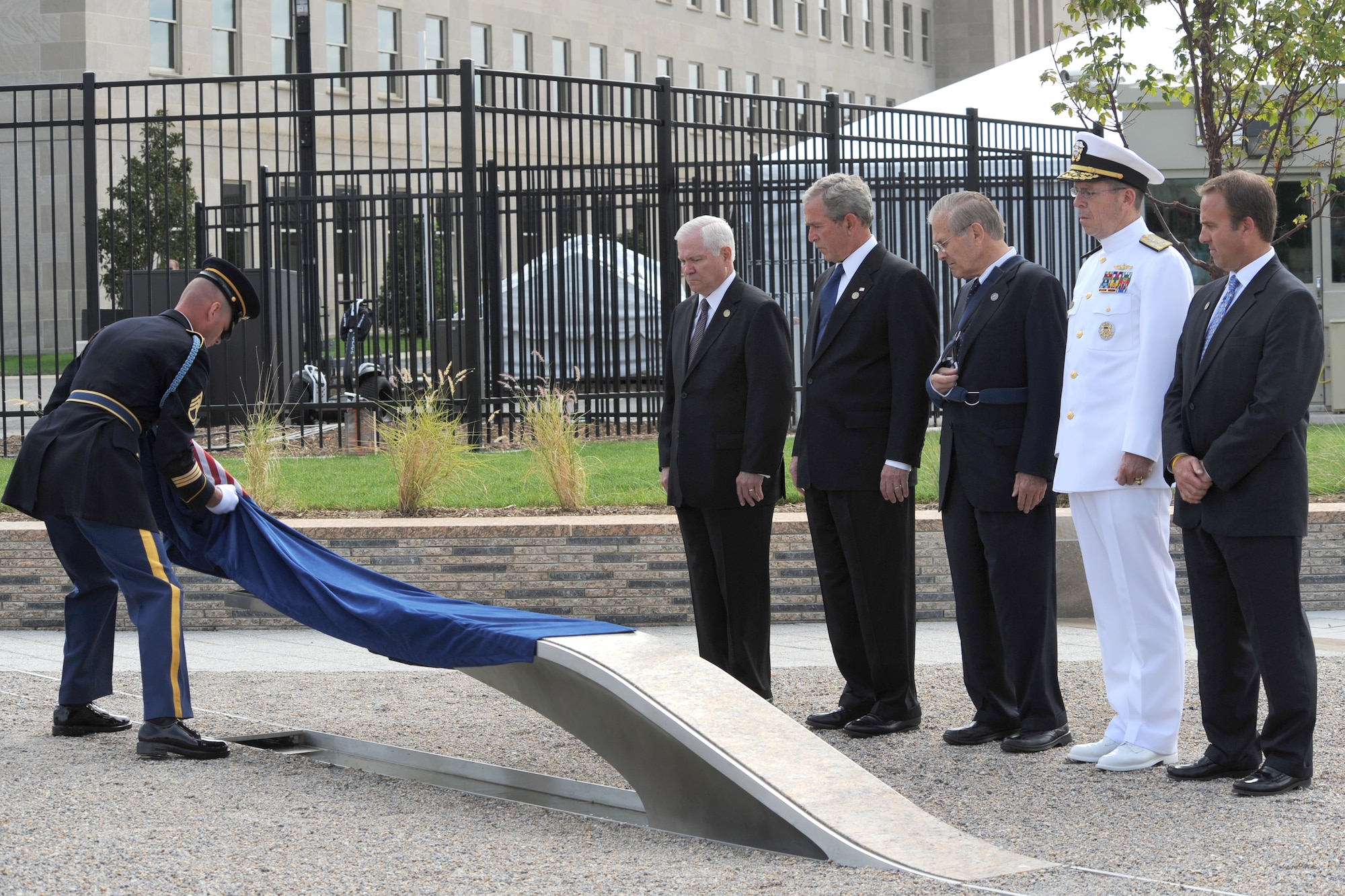 The official party watches as the first inscribed memorial unit is unveiled at the Pentagon Memorial Sept. 11 in Alexandria, Va. The national memorial is the first to be dedicated to those killed at the Pentagon on Sept. 11, 2001. The site contains 184 inscribed memorial units honoring the 59 people aboard American Airlines Flight 77 and the 125 in the building who lost their lives that day. (Defense Department photo/Cherie Cullen)