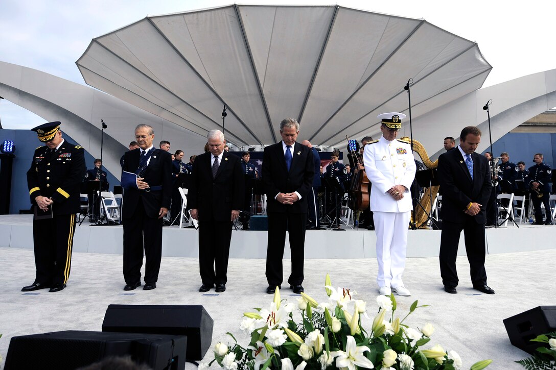 The official party holds a moment of silence during the Pentagon Memorial dedication ceremony Sept. 11 in Alexandria, Va. The national memorial is the first to be dedicated to those killed at the Pentagon on Sept. 11, 2001. The site contains 184 inscribed memorial units honoring the 59 people aboard American Airlines Flight 77 and the 125 in the building who lost their lives that day. (Defense Department photo/D. Myles Cullen)