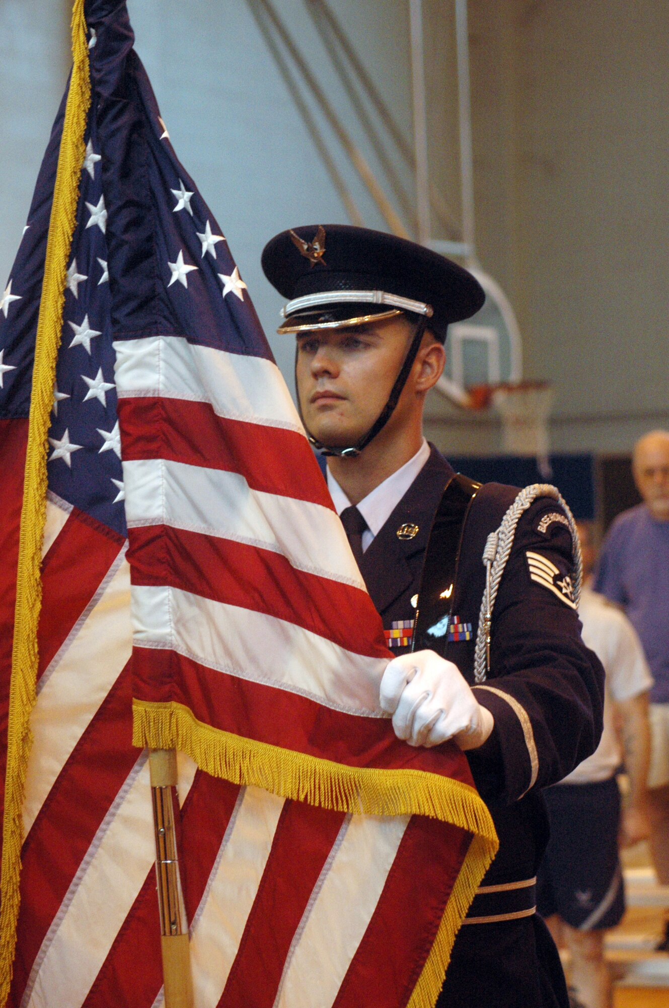 SSgt. Nicholas Chatham posts the American flag during the opening ceremony for the Freedon Walk Sept 10. U. S. Air Force photo by Sue Sapp