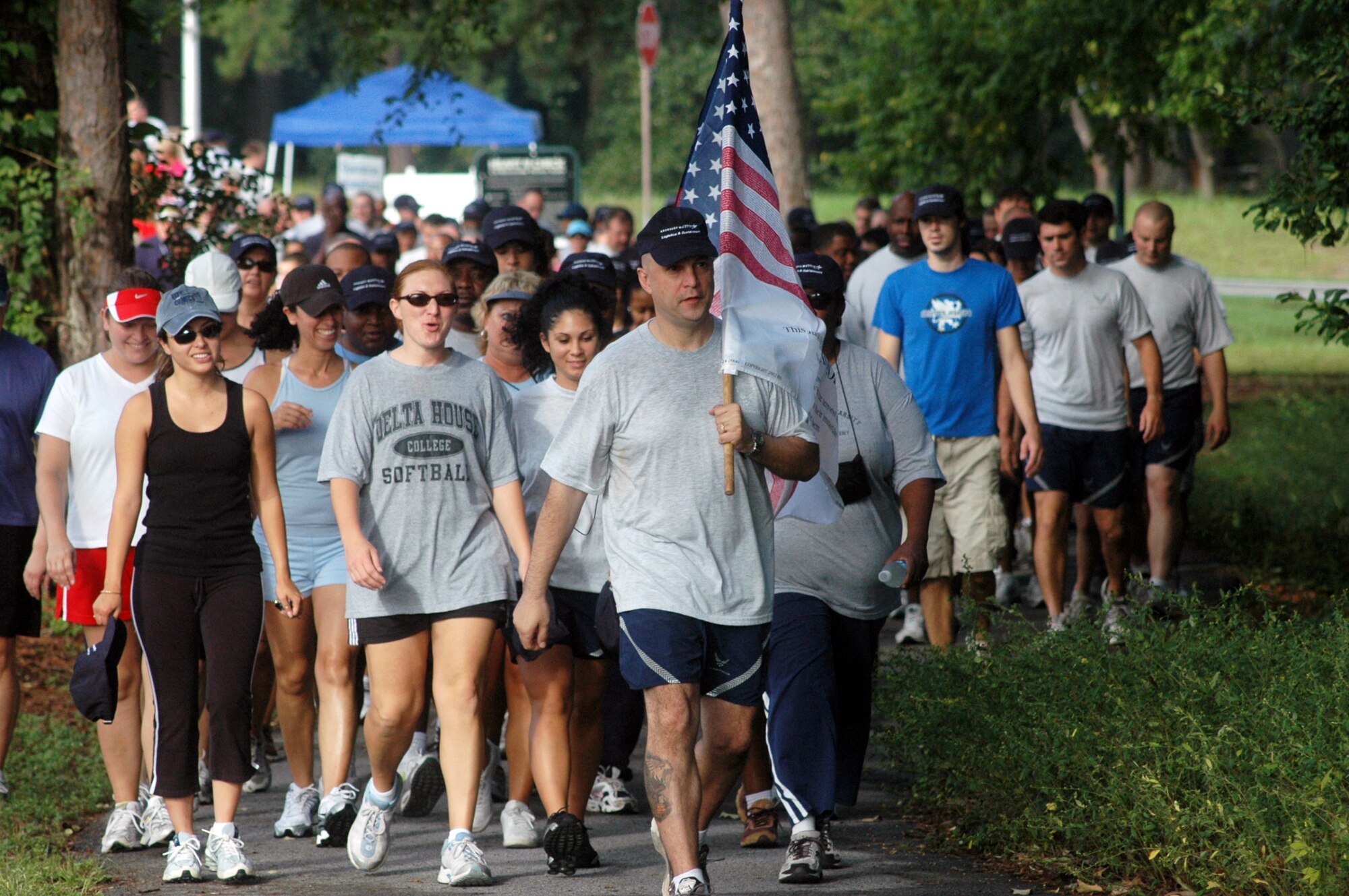 MSgt. Gary Hunkins leads the walkers carrying the Flag of Honor in Robin's first Freedom Walk Sept. 10. The flag bears the names of those killed in the terrorist attacks of Sept. 11, 2001. U. S. Air Force photo by Sue Sapp