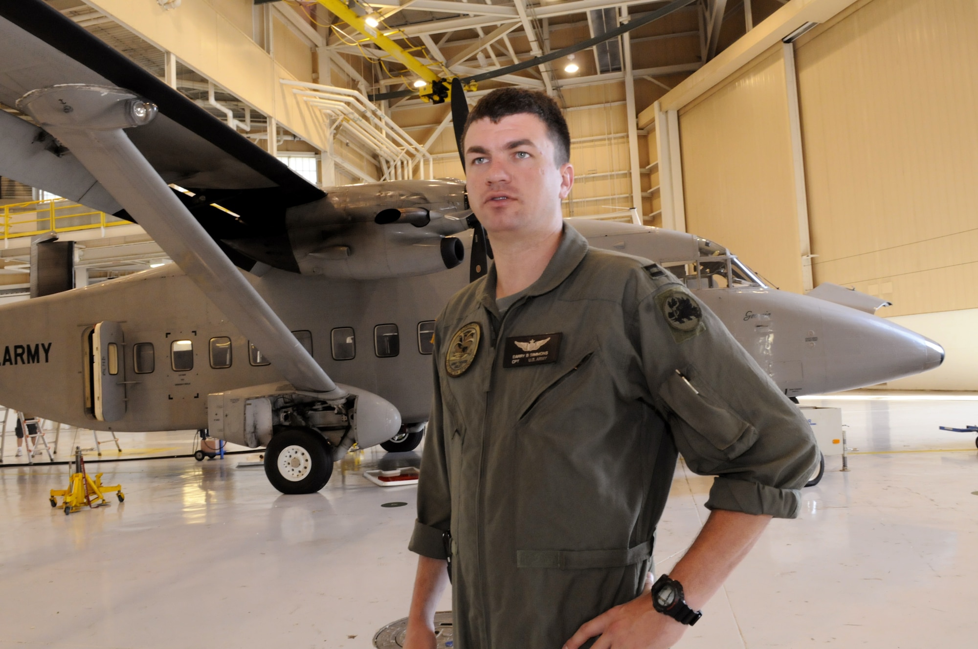 Capt. Barry Simmons talks about the varied missions of Company H in front of a C-23 Sherpa Sept. 5. U. S. Air Force photo by Sue Sapp