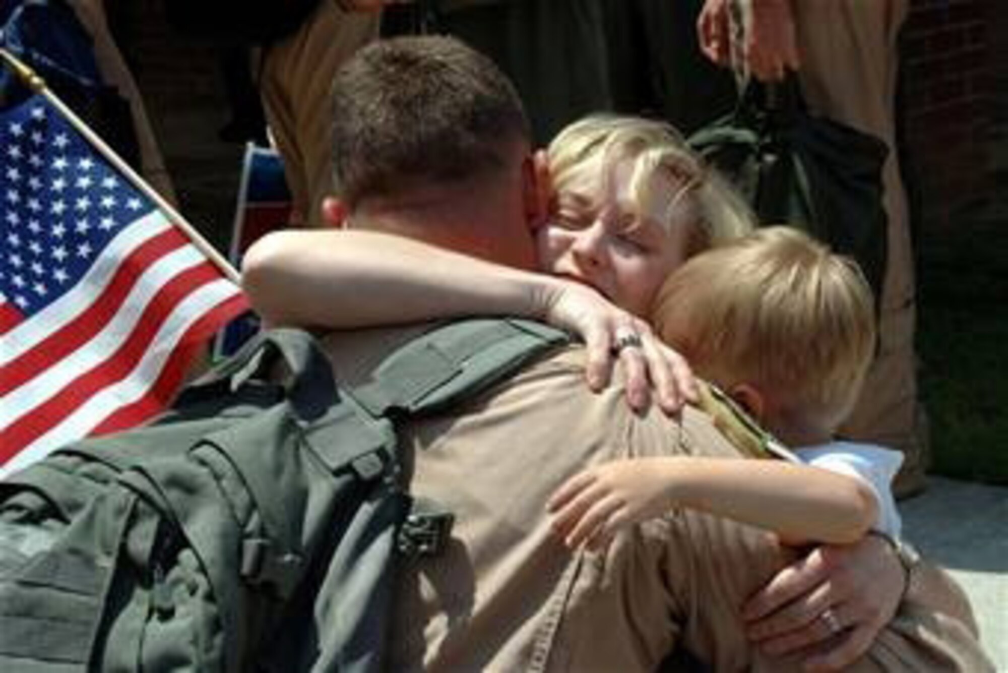 A member of the 116th Air Control Wing receives a hug from his family upon returning home from a recent deployment to Southwest Asia. The family readiness program provides support to families during deployments. Photo by Staff Sgt. Christopher Holmes
