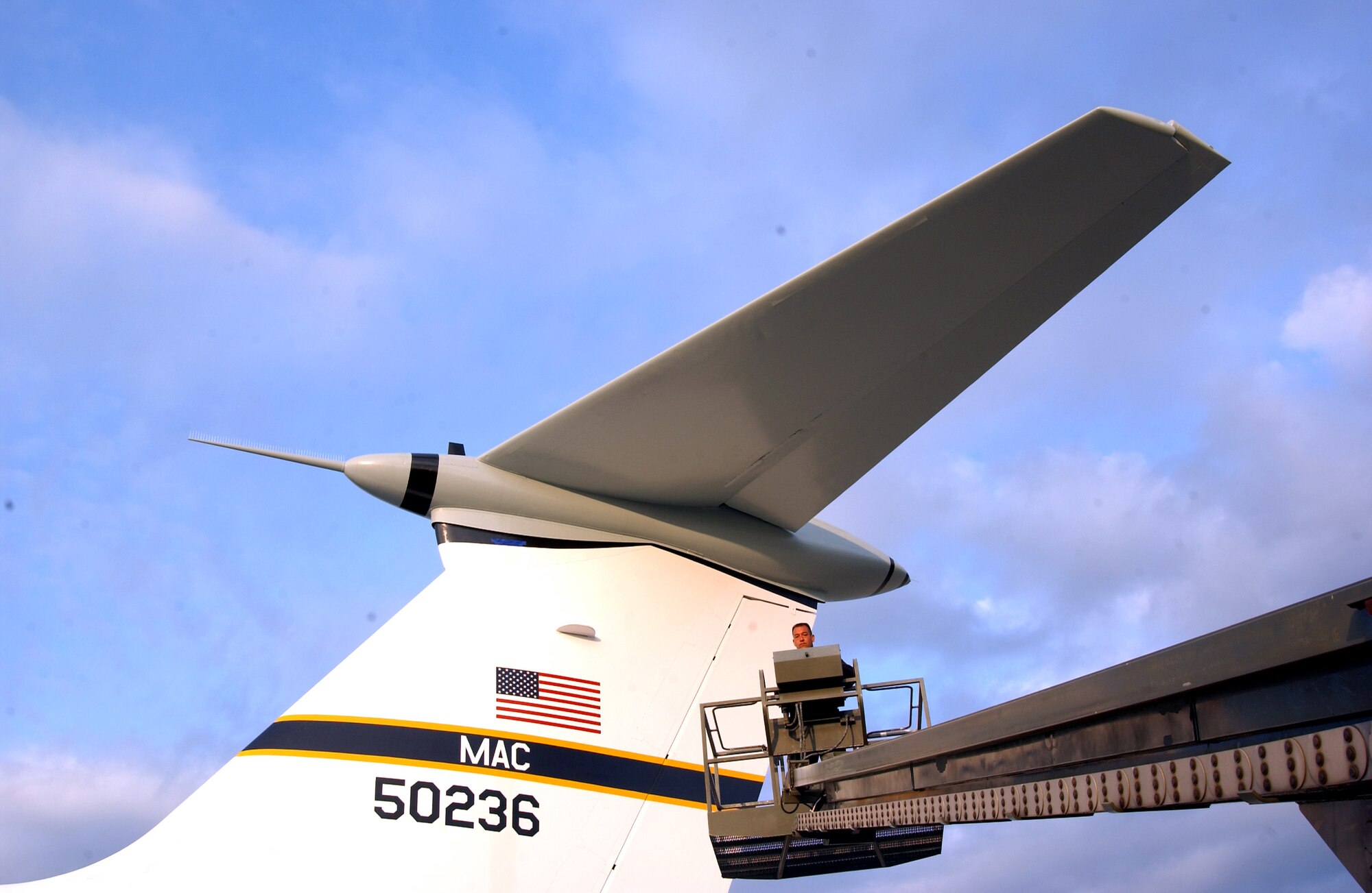 126th ARW Fabrication Superintendent, Senior Master Sgt. Ramon Wrzek, raises a boom lift to put a few finishing touches on a C-141B before it is towed to the Scott Field Heritage Airpark Tuesday morning. Members of the 126th ARW have spent the last month restoring aricraft on their off-duty time. When the plane was delivered to the 126th ARW its paint scheme was a camoflage pattern, but it will now return to the paint scheme it had when it was used for the Hanoi airlifts. Although most of the preservation work is complete, final touches will be complete after the plane is in place at the airpark.

(U.S. Air Force photo/ Monte Miller)